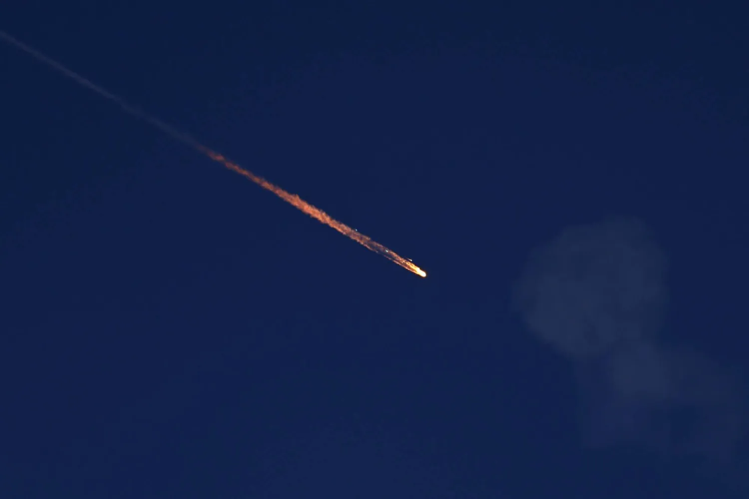 A fragment falls through the sky after Israel's Iron Dome intercepted a missile launched from Iran towards Israel, amid the Iran-Israel conflict, as seen from Ashkelon, Israel June 20, 2025. (Reuters)