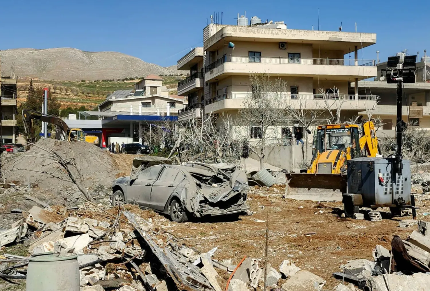 A bulldozer clears debris near heavily damaged buildings in the village of Bednayel in the eastern Bekaa plain of Lebanon (AFP).