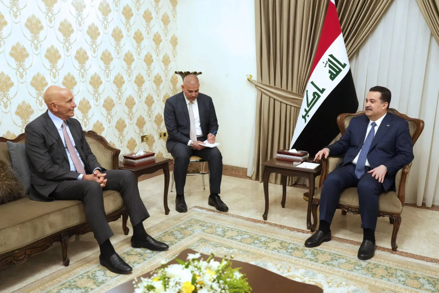 FILE: A handout picture made available by the Iraqi prime minister's office on February 22, 2026, shows US envoy to Syria Tom Barrack (L) meeting with Iraq's Prime Minister Mohammed Shia al-Sudani (R) in Baghdad's Green Zone. "AFP PHOTO / IRAQI PRIME MINISTER'S OFFICE" 