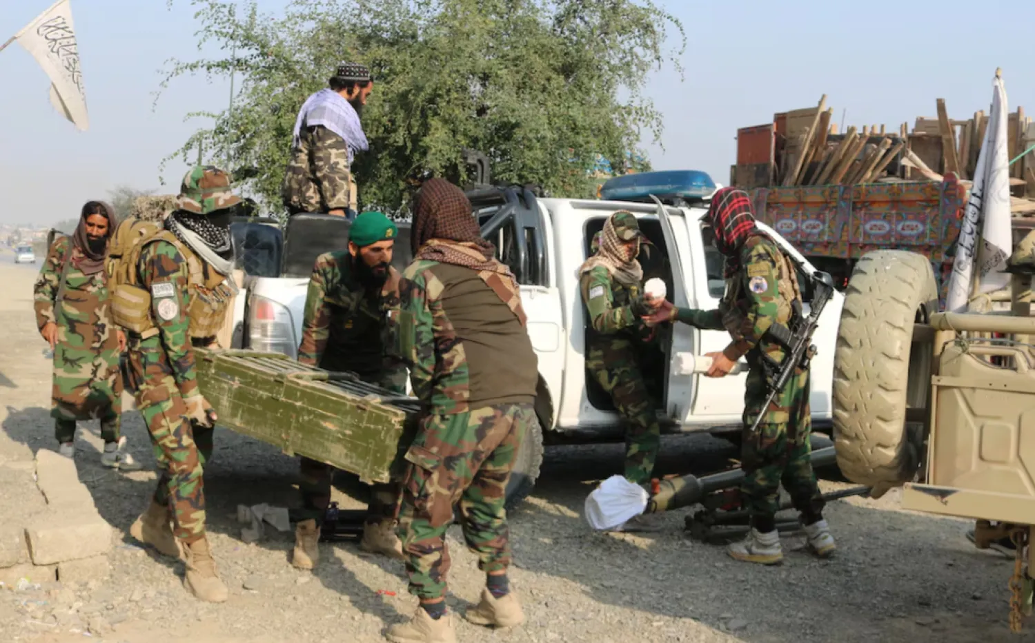 Taliban soldiers carry a box containing weapons, following exchanges of fire between Pakistan and Afghanistan forces, near Torkham border in Afghanistan, February 27, 2026. REUTERS/Stringer