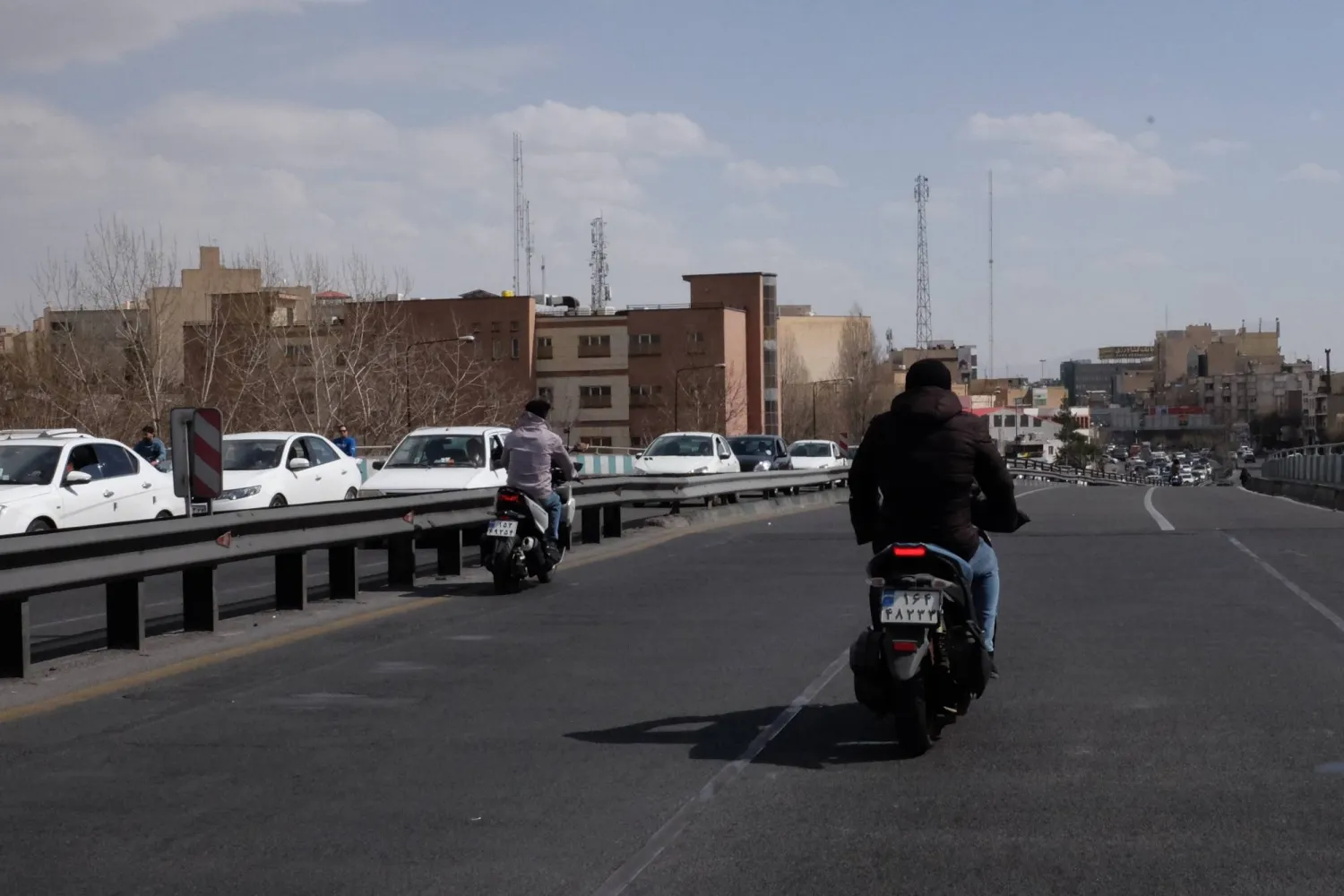 Vehicles drive across a bridge following Israeli strikes in Tehran, Iran, Saturday, Feb. 28, 2026. (AP Photo/Vahid Salemi)