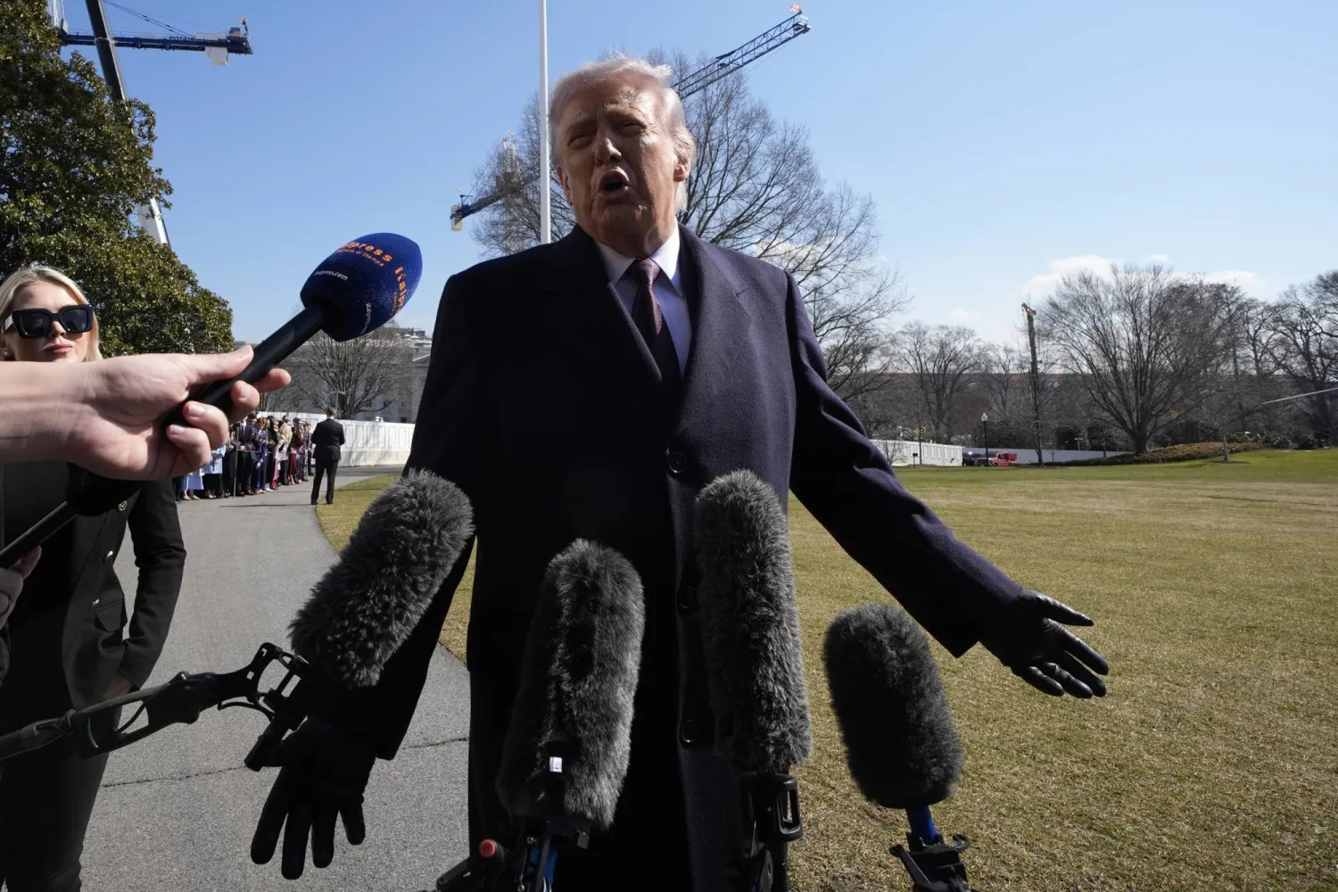 US President Donald Trump speaks to the media on the South Lawn of the White House before boarding Marine One helicopter bound for Corpus Christi, Texas (EPA)