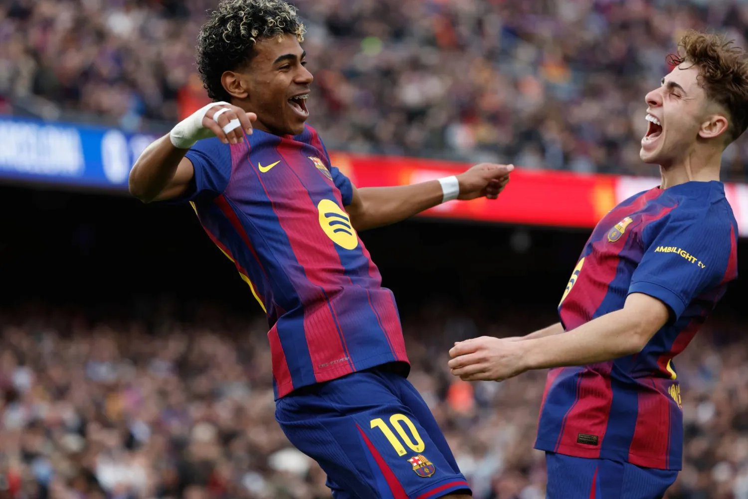 Barcelona's Lamine Yamal, left, celebrates scoring his side's opening goal with teammate Fermin Lopez during the Spanish La Liga soccer match between Barcelona and Villareal in Barcelona, Spain, Saturday, Feb. 28, 2026. (AP Photo/Joan Monfort)