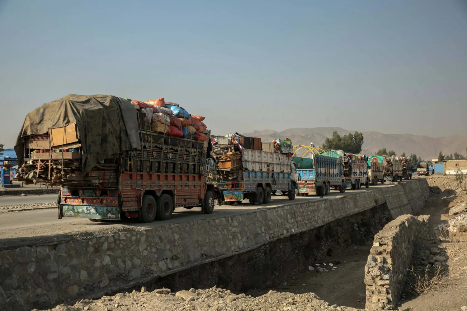 Afghan refugees returning from neighboring Pakistan wait at a refugee camp near the Torkham border crossing, in Nangarhar province, Afghanistan, 28 February 2026. (EPA)