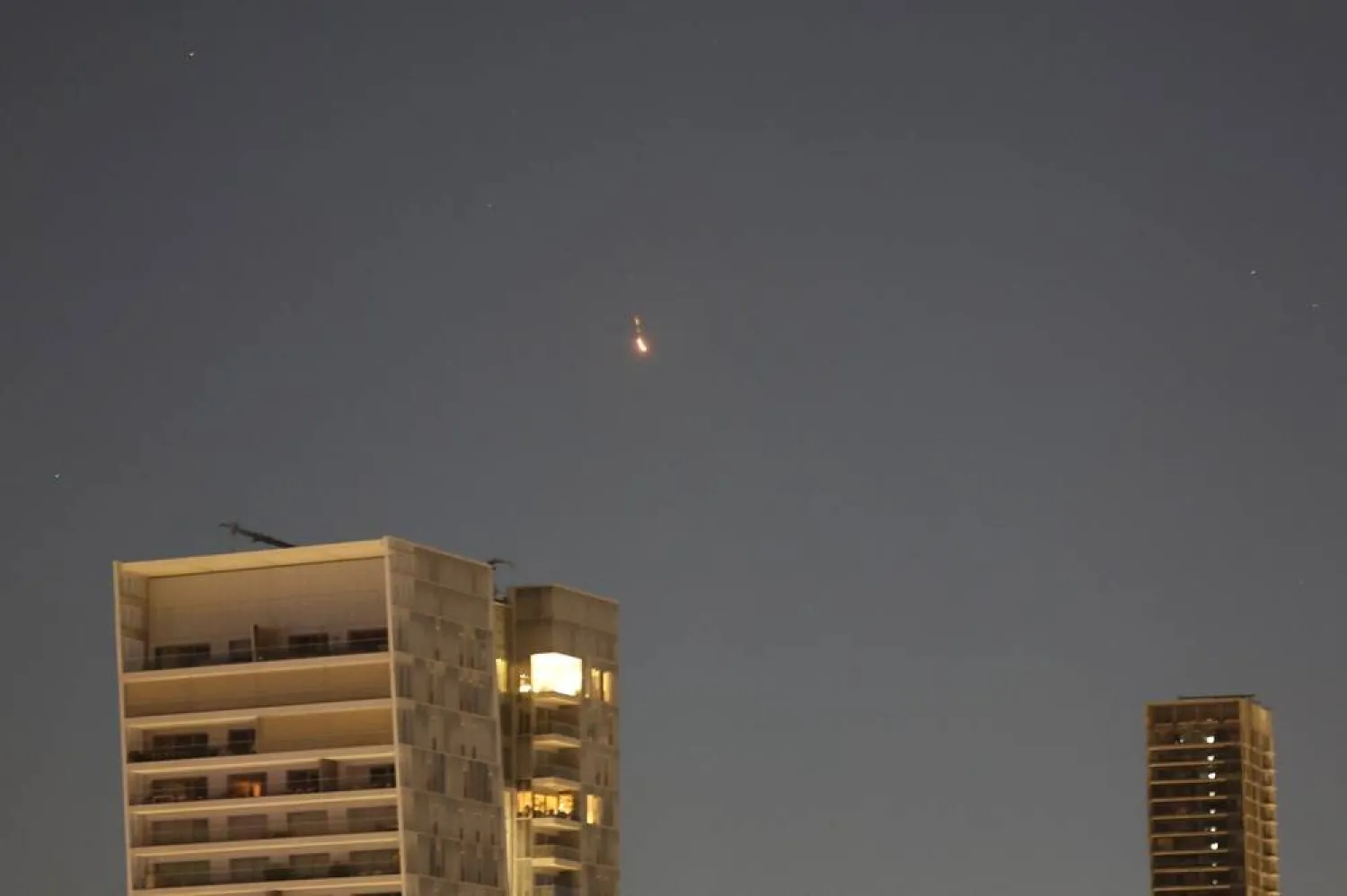 A projectile lights up the night sky over Tel Aviv, Israel, 01 March 2026. (EPA)