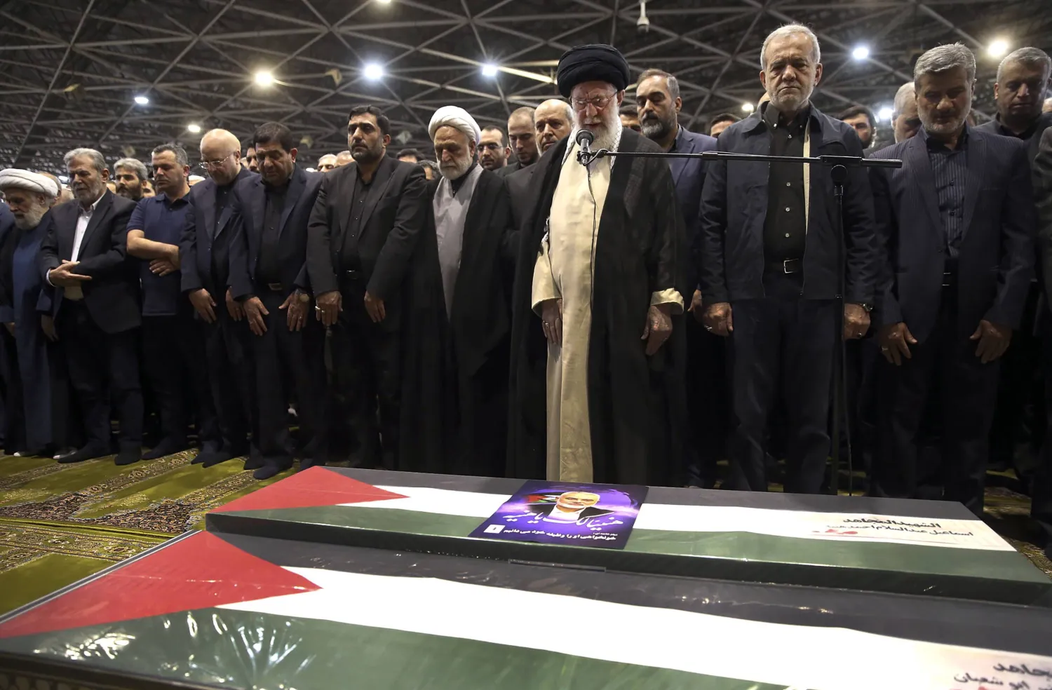 In this photo released by the official website of the office of the Iranian supreme leader, Supreme Leader Ali Khamenei, third right, leads a prayer over the coffins of Hamas leader Ismail Haniyeh and his bodyguard who were killed in an assassination blamed on Israel on Wednesday, during their funeral ceremony at the Tehran University campus, in Tehran, Iran, Aug. 1, 2024. (Office of the Iranian Supreme Leader via AP, File) 