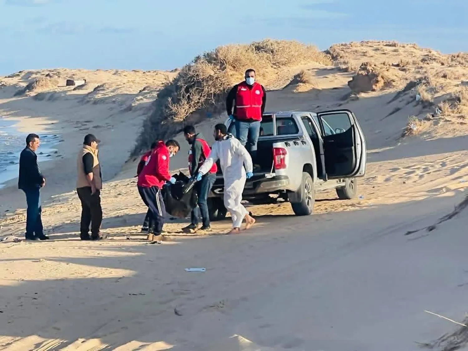 فريق جمعية الهلال الأحمر ينقل إحدى الجثث المنتشلة إلى قسم الشرطة 1 مارس (المكتب الإعلامي للجمعية)