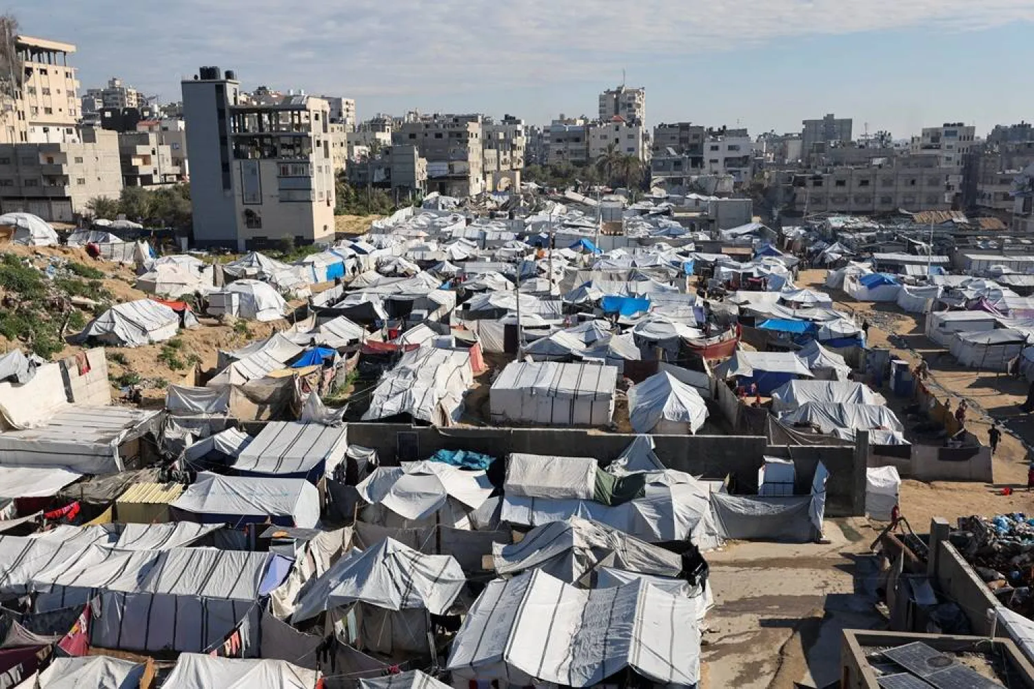 Palestinians displaced during the two-year Israeli offensive, shelter at a tent camp in Gaza City, March 1, 2026. (Reuters)