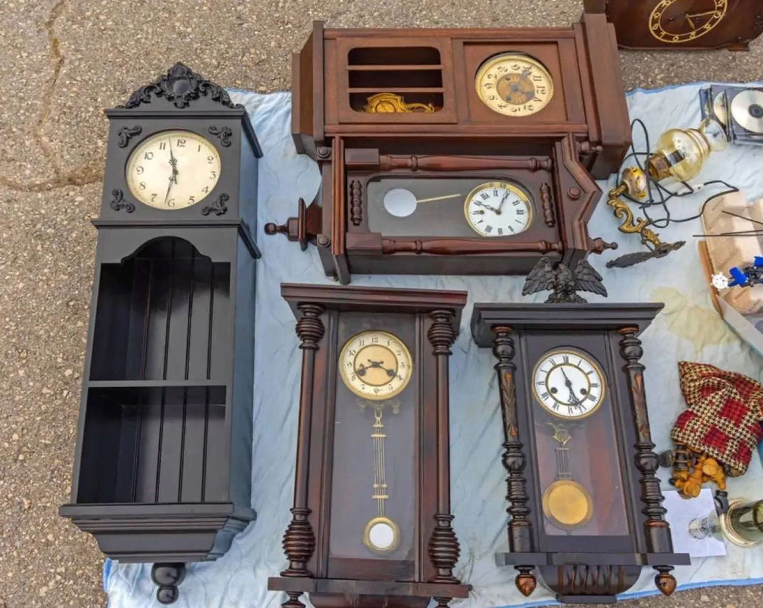 Grandfather pendulum clocks collection for sale at an antique market (Shutterstock)
