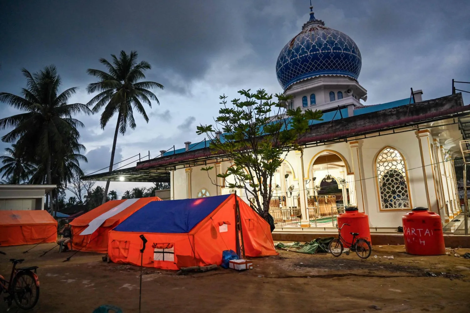  Tents used as temporary housing by flood survivors are seen beside a mosque in Meurah Dua, Aceh province's Pidie Jaya district on February 21, 2026, after devastating floods and landslides struck Indonesia's Sumatra late last year. (AFP)