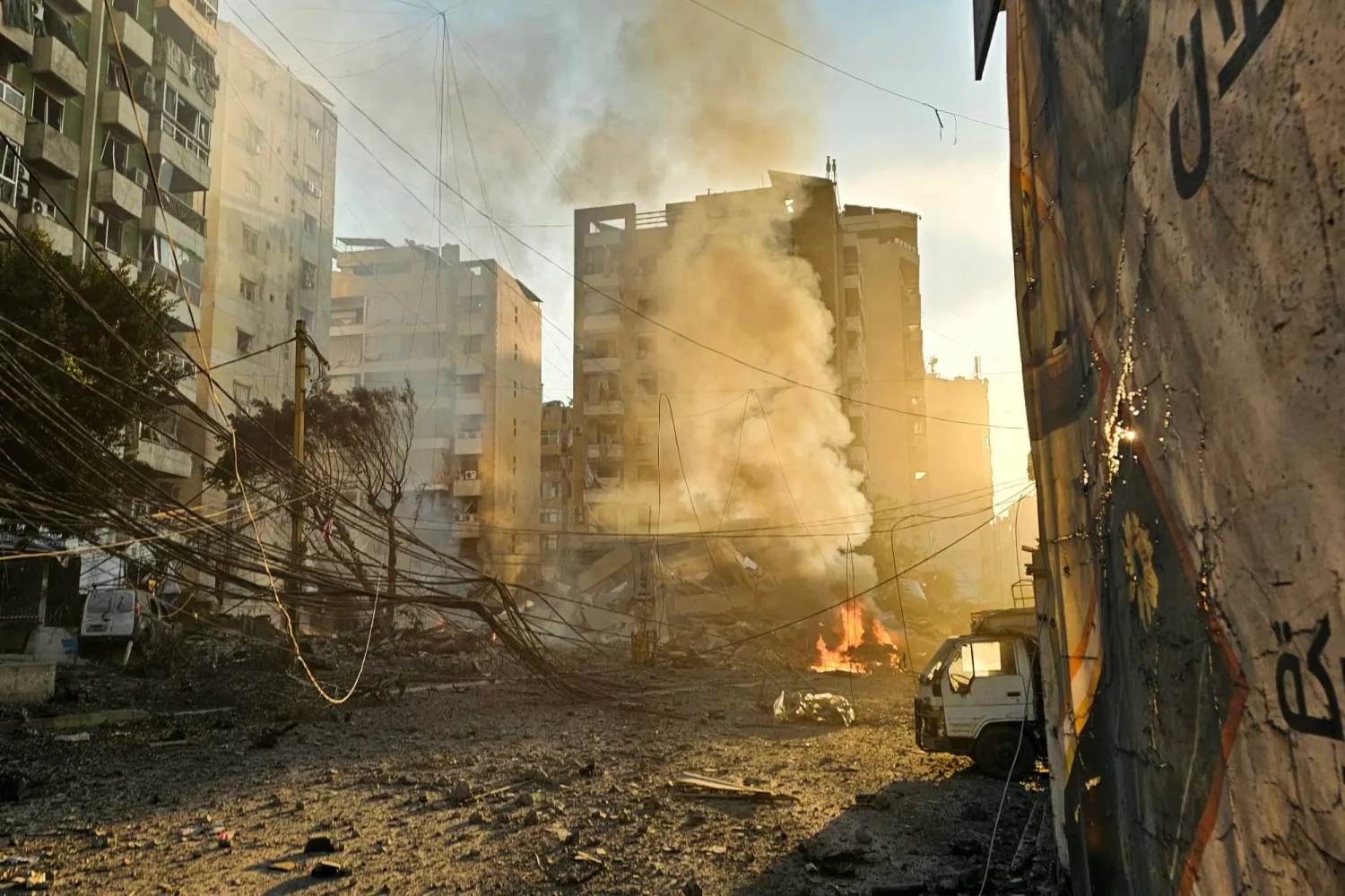 Fires erupt from buildings damaged in an early morning Israeli strike on Beirut's southern suburbs on March 3, 2026. (Photo by AFP)