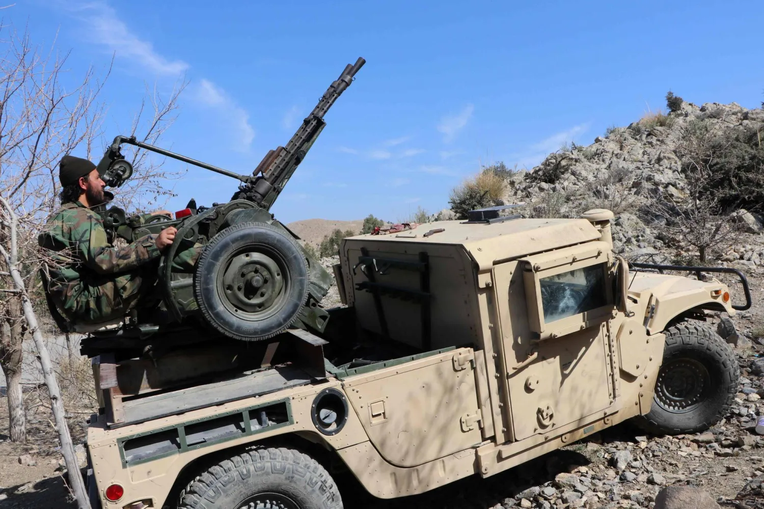 A Taliban security personnel operates an anti-aircraft gun while keeping watch for Pakistani airstrikes in the Tere Zayi district of Khost province on March 2, 2026. (AFP)