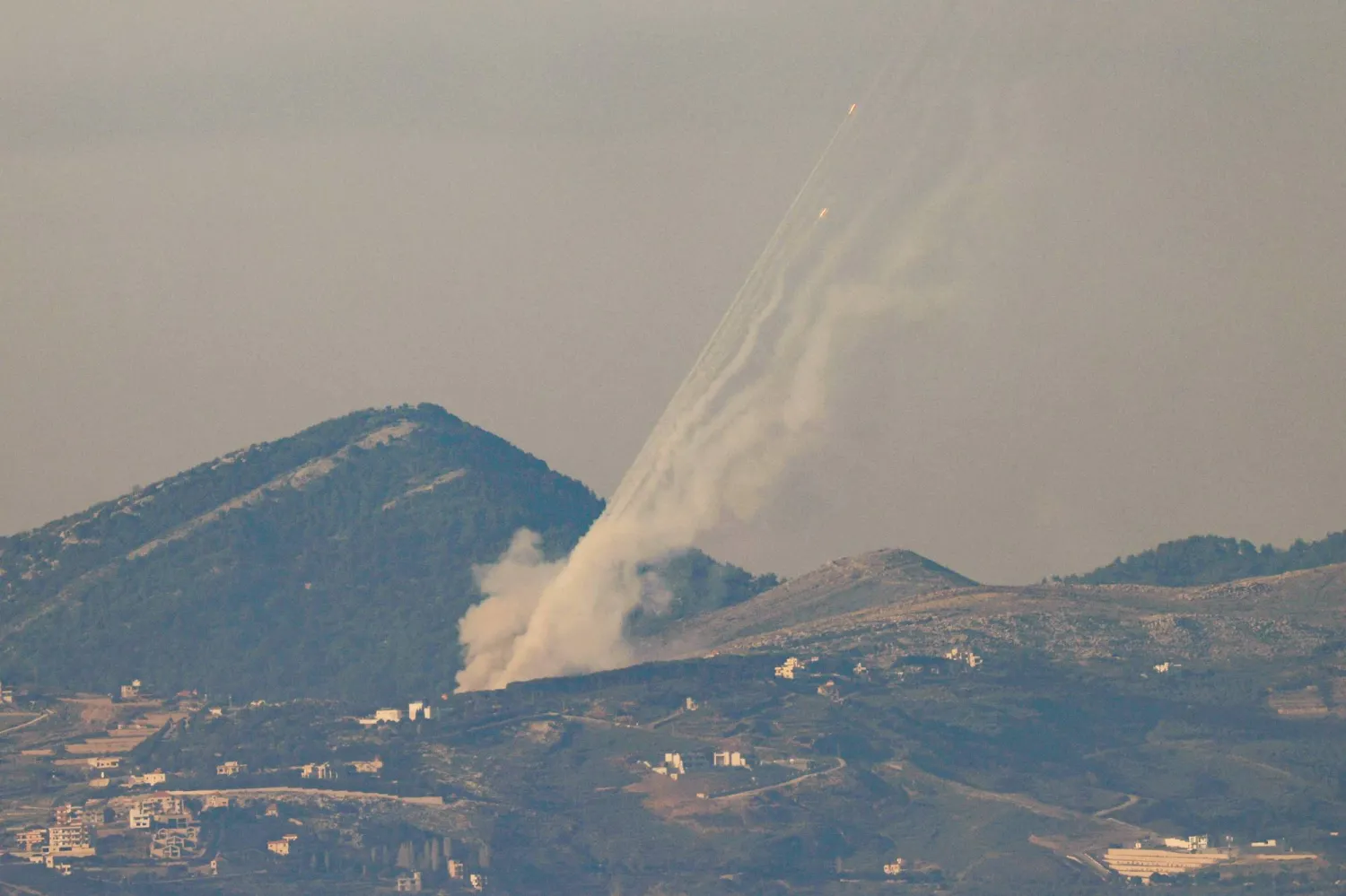 A picture taken along the Israel-Lebanon border shows rockets being fired from southern Lebanon towards Israel on March 3, 2026. (AFP)