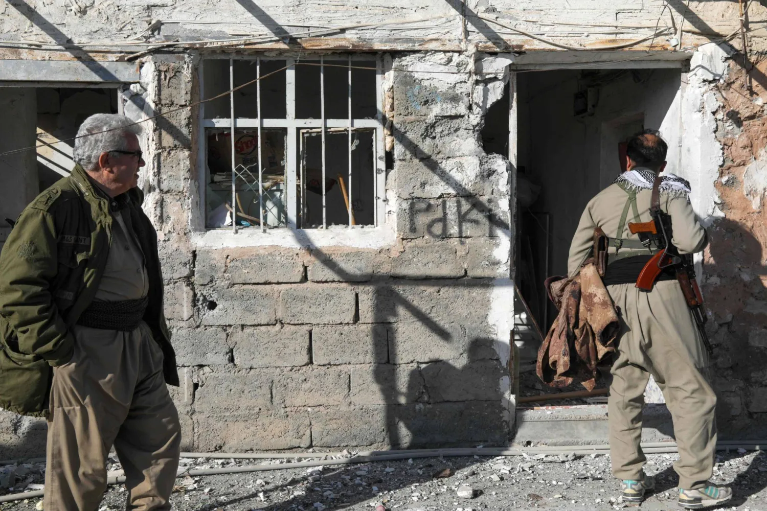 An Iranian Kurdish Peshmerga member of the Kurdistan Democratic Party of Iran (KDPI) inspects damage sustained at the Azadi Camp of the Kurdistan Democratic Party of Iran (KDPI) following an Iranian cross-border attack in the town of Koye (Koysinjaq), in the east of Erbil district in the autonomous Kurdish region of northern Iraq on March 3, 2026. (AFP) 