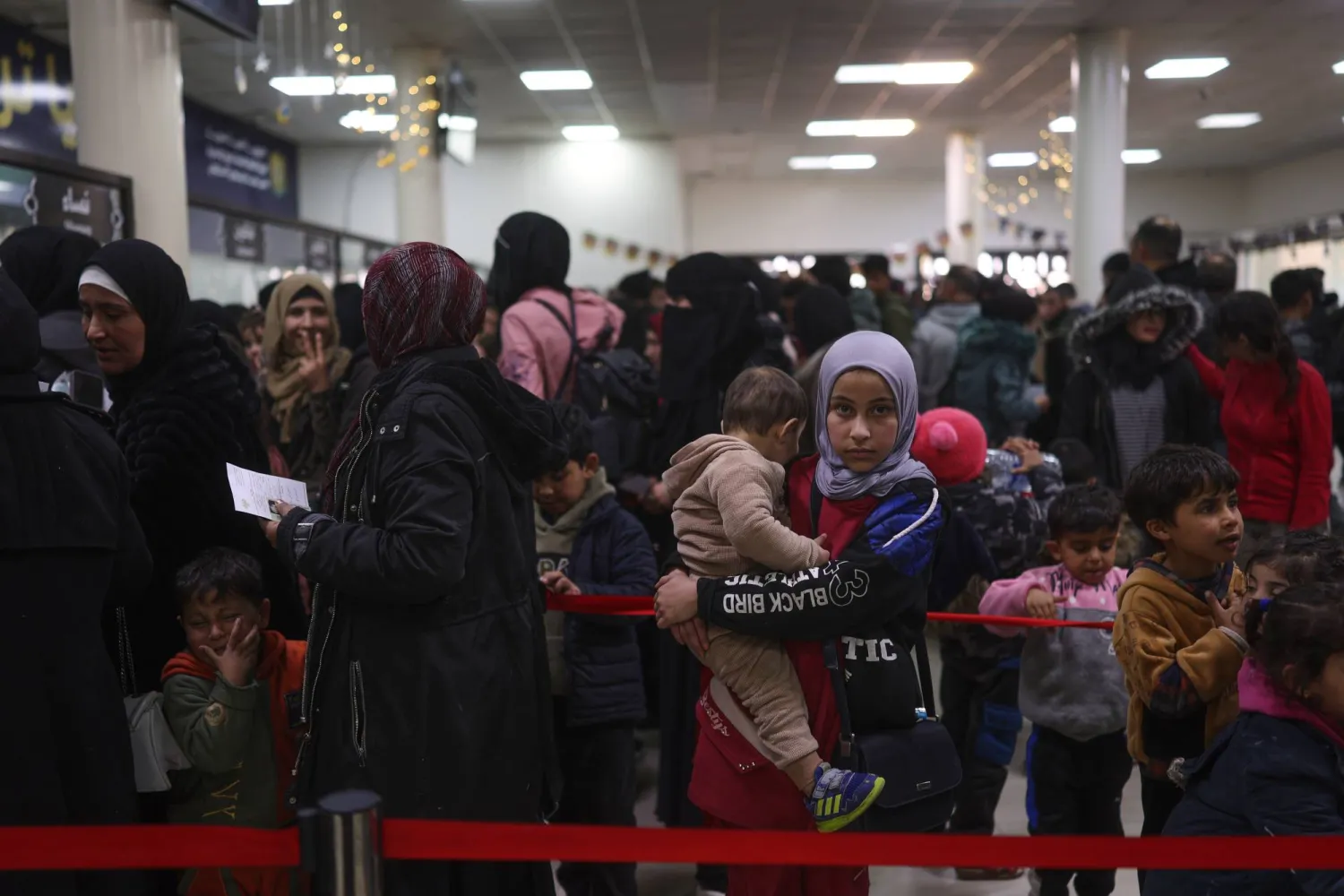 Syrians who fled the war in Lebanon check in after arriving at the Syrian-Lebanese border crossing in Jdeidet Yabous, Syria, Tuesday, March 3, 2026. (AP Photo/Ghaith Alsayed)