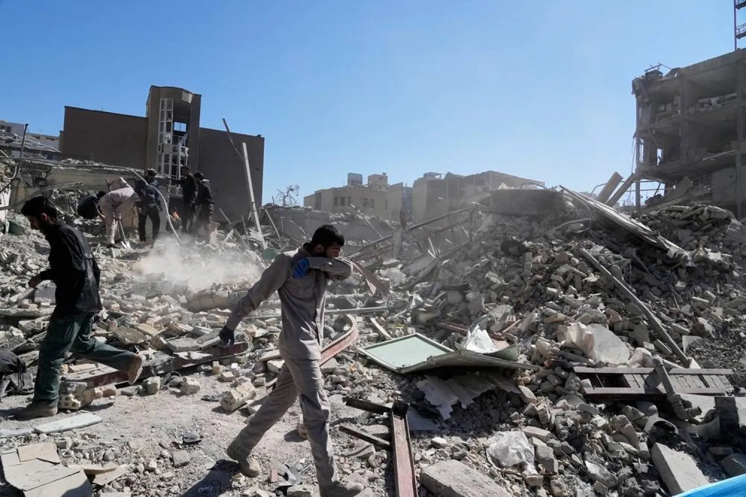  A group of men inspect the ruins of a police station struck Monday amid the US–Israeli military campaign in Tehran, Iran, Tuesday, March 3, 2026. (AP) 