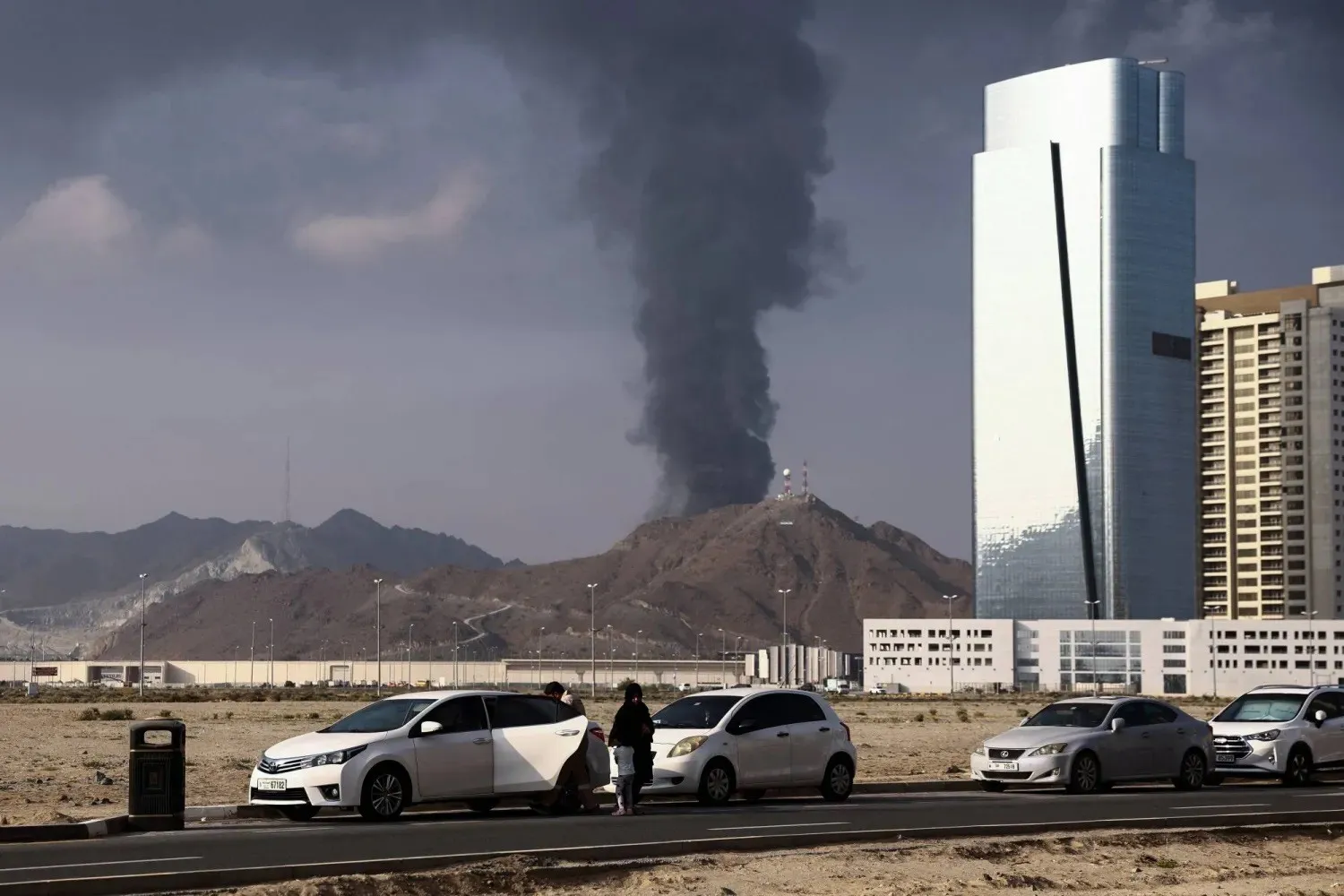 Smoke rises over the oil industry area in Fujairah after a fire caused by debris following the interception of a drone by air defenses. (Reuters) 