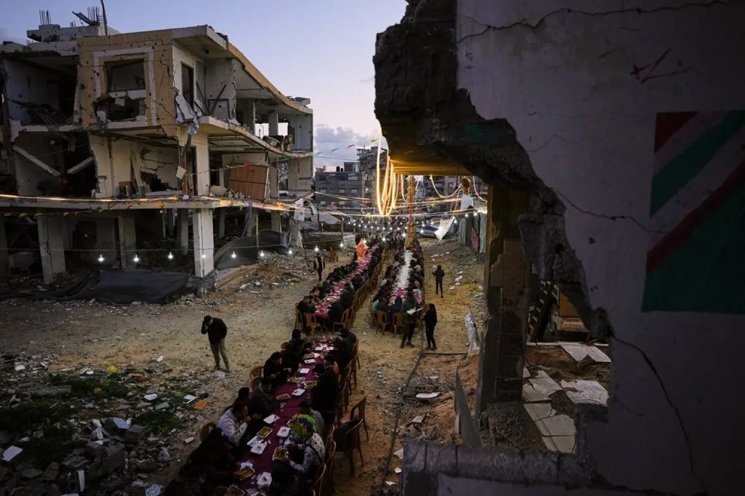 Palestinians gather for iftar, the fast-breaking meal, during the holy month of Ramadan amid the rubble of destroyed buildings in Gaza City, Thursday, Feb. 26, 2026. (AP)