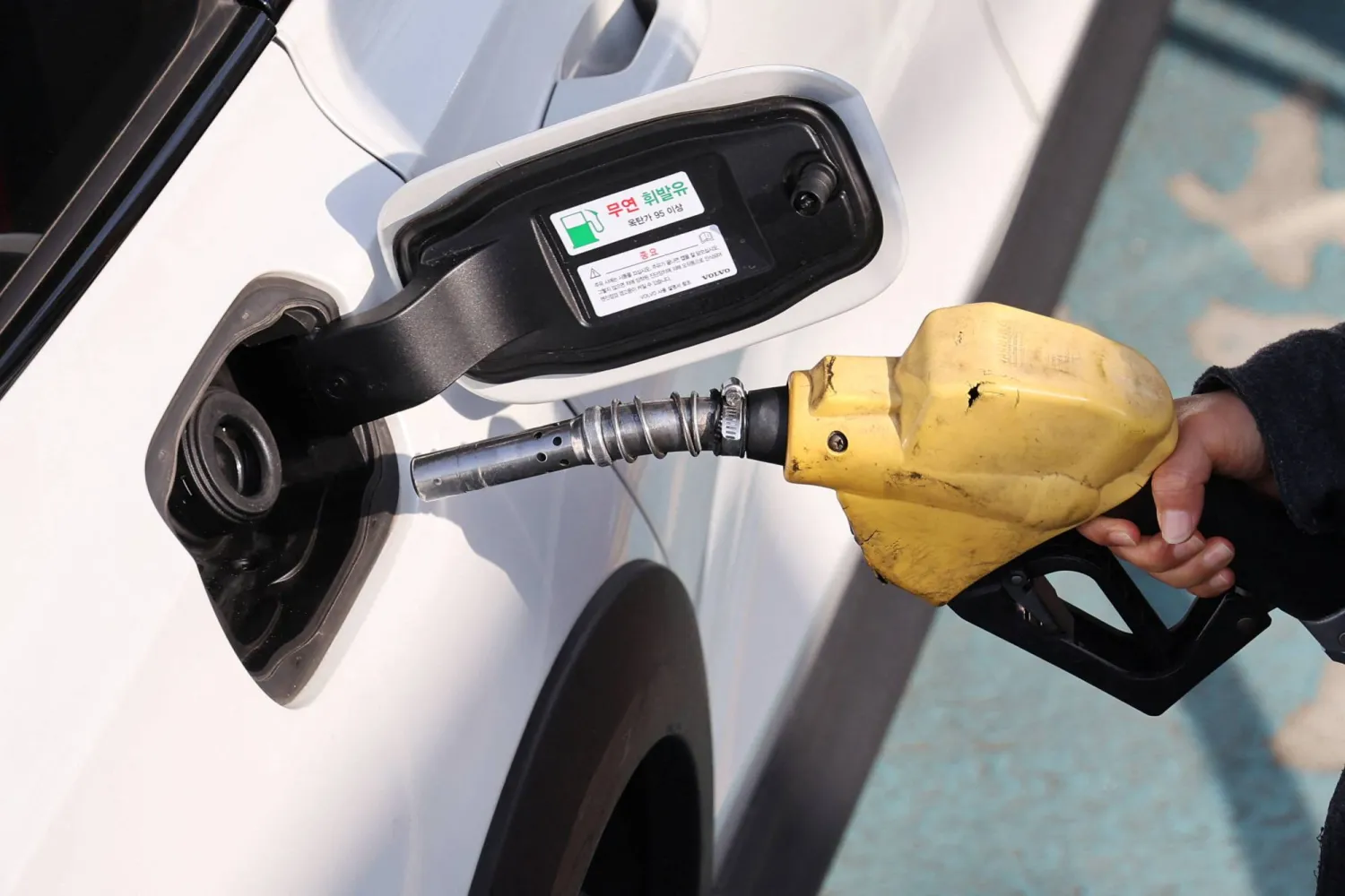 A woman fills up her car at a gas station in Seoul, South Korea, March 4, 2026. REUTERS/Kim Hong-Ji