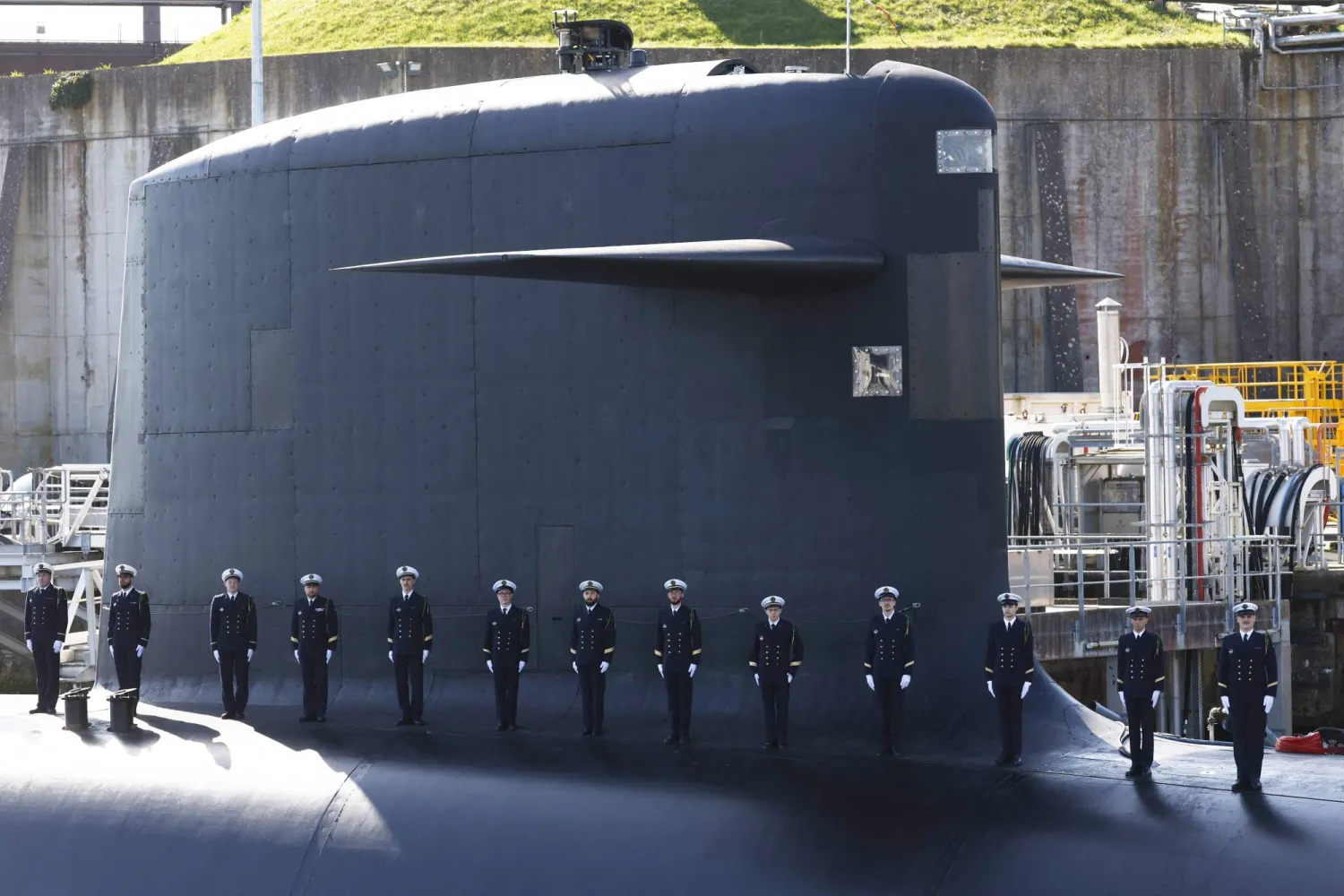 Members of the French Navy stand on the topside of a submarine ahead of France's President's visit to the Nuclear Submarine Navy Base of Ile Longue in Crozon, northwestern France on March 2, 2026. (AFP)