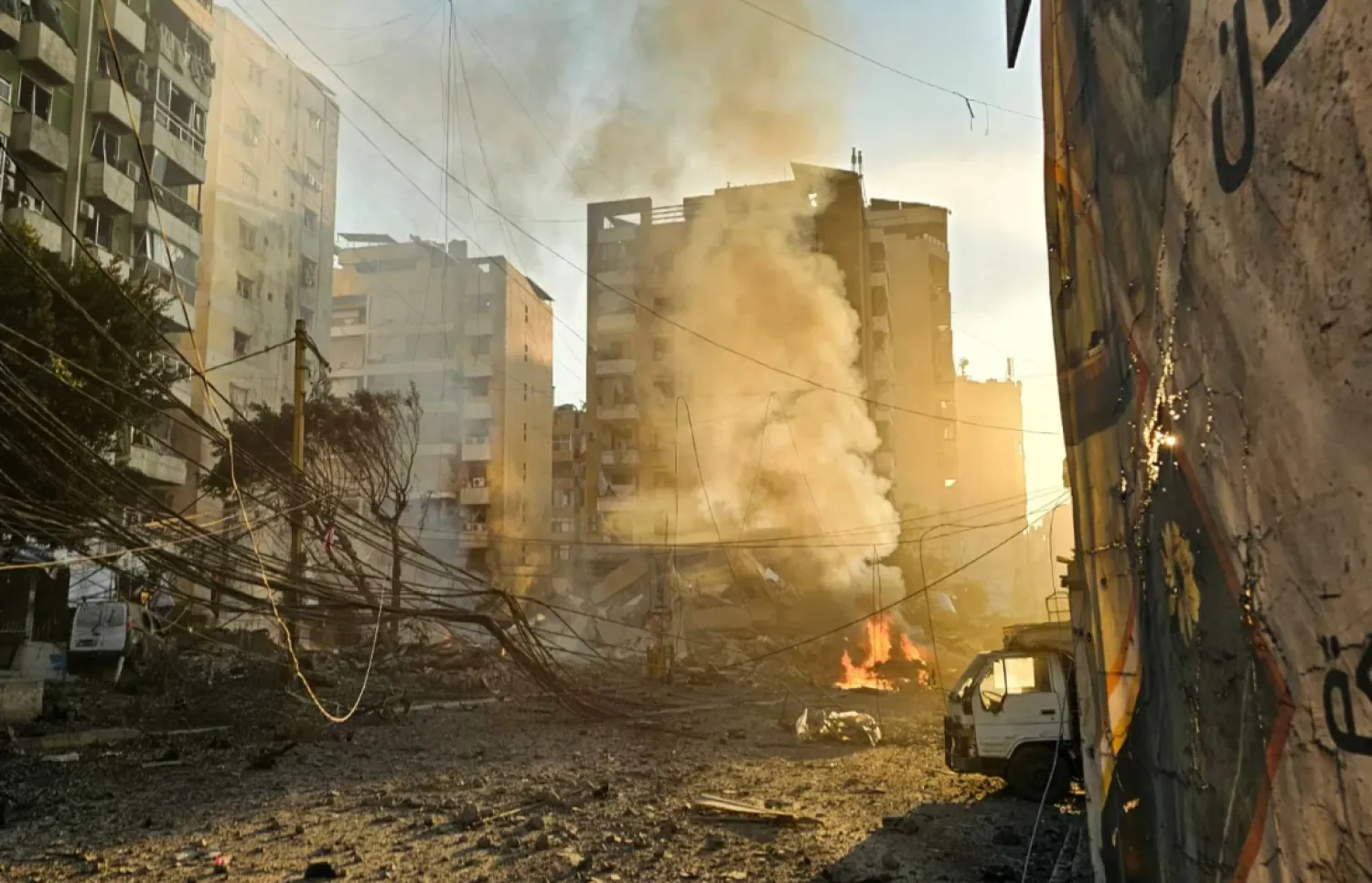 Fires erupt from buildings damaged in an early morning Israeli strike on Beirut's southern suburbs on March 3, 2026. (Photo by AFP)
