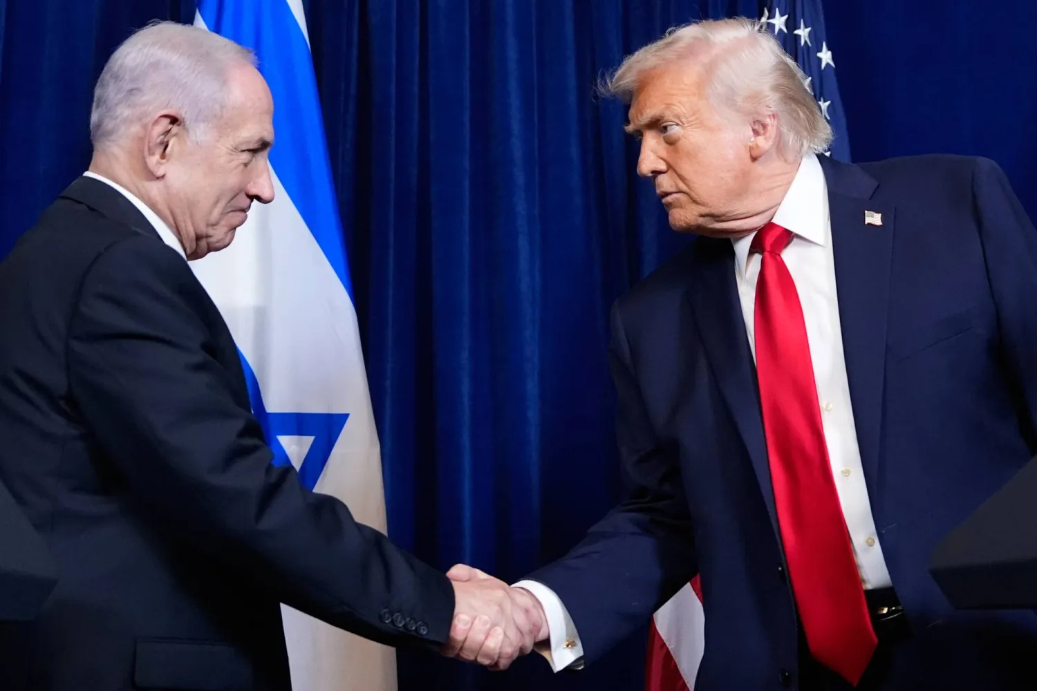 FILE - President Donald Trump shakes hands with Israel's Prime Minister Benjamin Netanyahu during a news conference at Mar-a-Lago, Dec. 29, 2025, in Palm Beach, Fla. (AP Photo/Alex Brandon, File)
