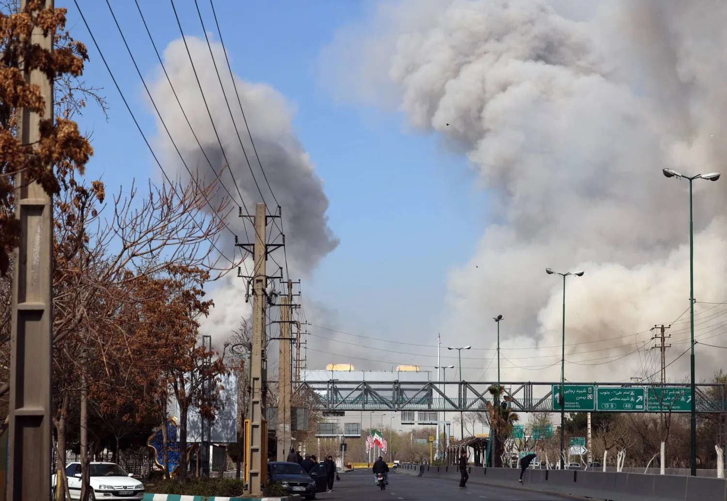 People run for safety as smoke rises after an airstrike in central Tehran, Iran, 05 March 2026. (EPA)