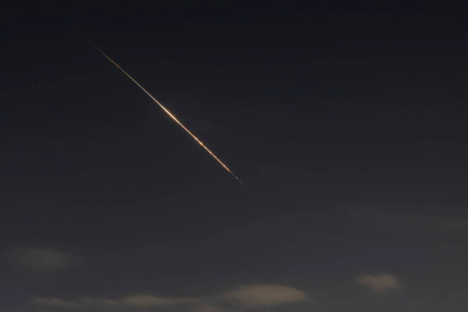 Rocket trails are seen in the sky above Tel Aviv amid a fresh barrage of Iranian missile attacks on March 5, 2026. (AFP)