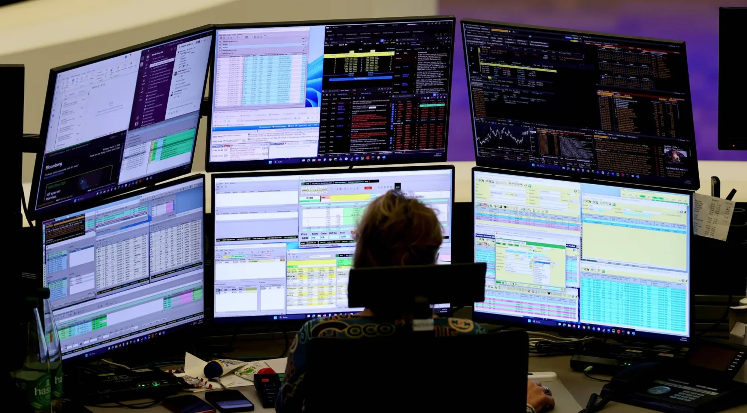 وسيط يراقب نشاط الأسهم بمكتبه في بورصة فرانكفورت (إ.ب.أ)