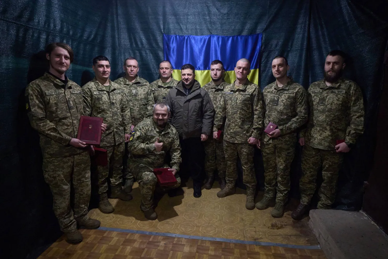 This handout photograph taken and released by the Ukrainian Presidential Press Service on March 6, 2026, shows Ukrainian President Volodymyr Zelensky (C) posing for a photo with Ukrainian servicemen while visiting the command post of the 3rd Battalion of the 28th Separate Mechanized Brigade named after the Knights of the Winter Campaign near Druzhkivka, Donetsk region, amid the Russian invasion of Ukraine. (Handout / Ukrainian Presidential Press Service / AFP) 