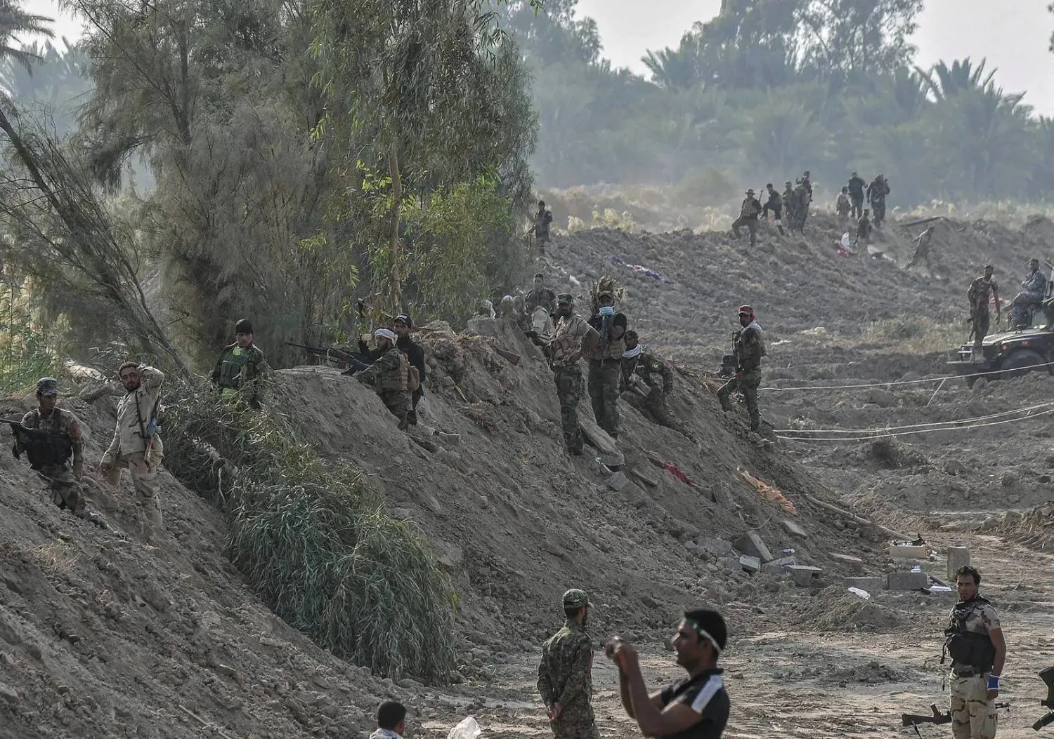 A photo released by the Popular Mobilization Forces showing its fighters in the town of Jurf al-Sakhar, south of Baghdad, in 2014 