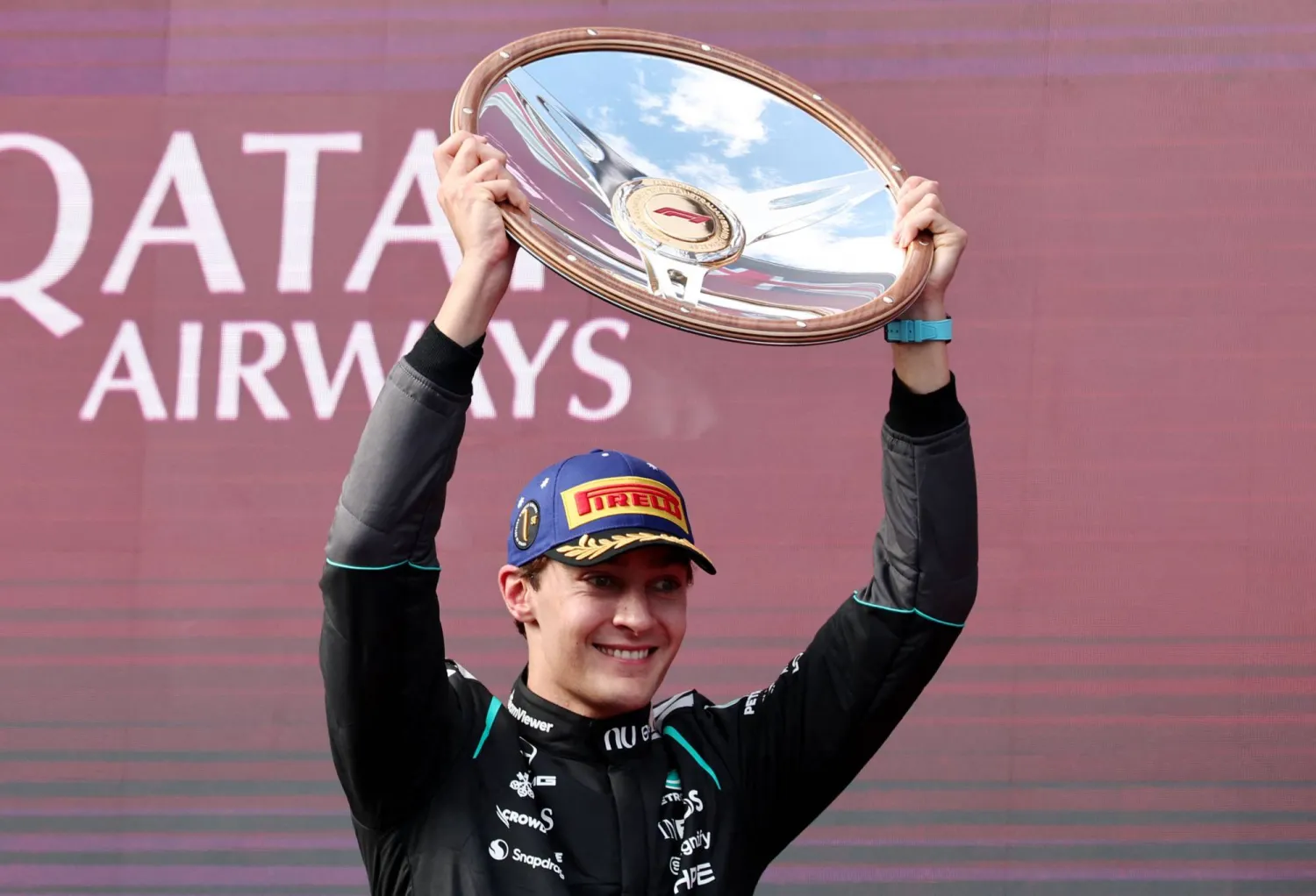 Formula One F1 - Australian Grand Prix - Albert Park Grand Prix Circuit, Melbourne, Australia - March 8, 2026 Mercedes' George Russell celebrates with the trophy on the podium after winning the Australian Grand Prix REUTERS/Mark Peterson