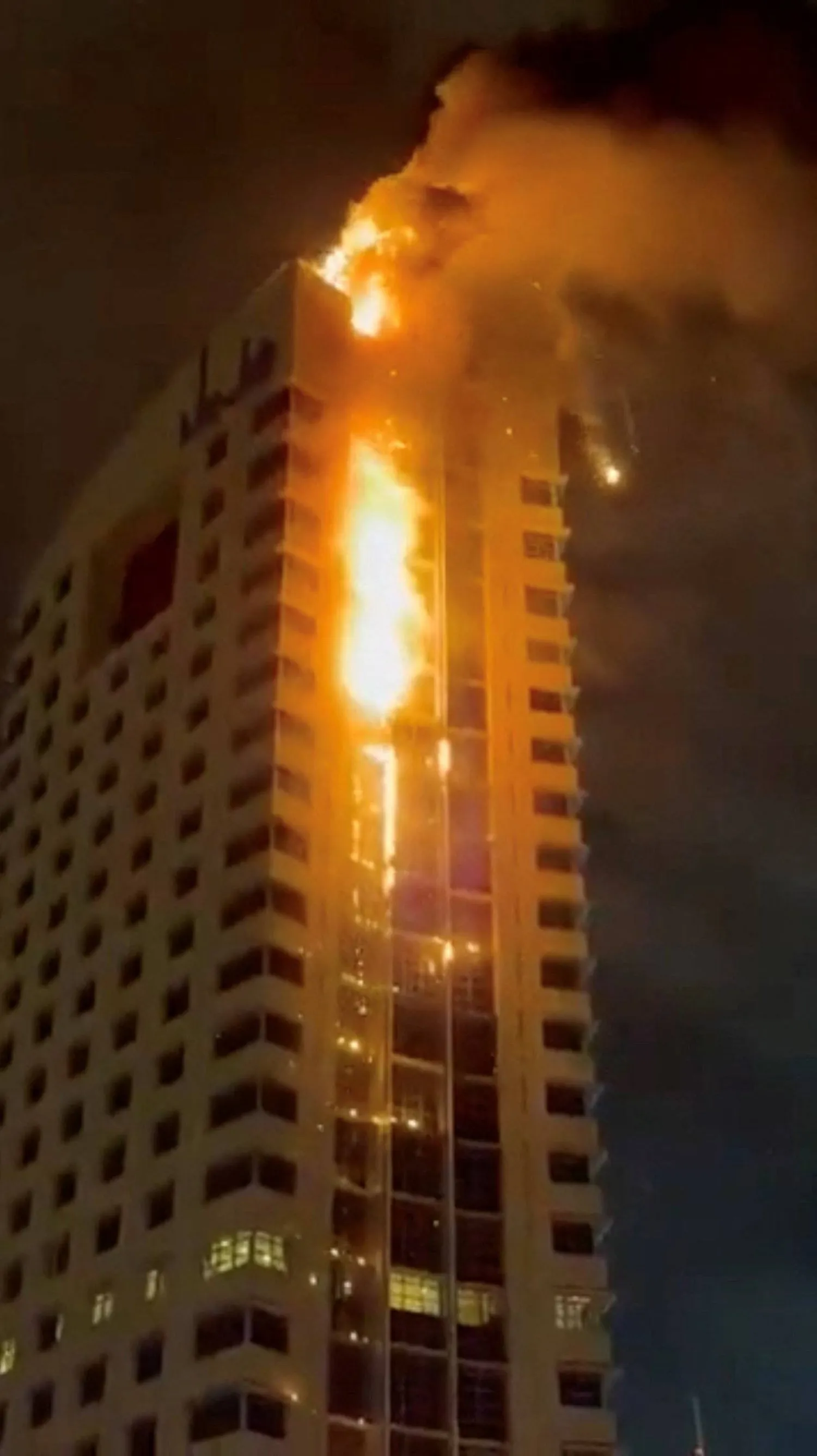 Smoke rises from a building on fire, in the aftermath of what the Kuwaiti Army says is a drone attack, amid the US-Israeli conflict with Iran, in Kuwait City, Kuwait March 8, 2026 in this screengrab taken from a social media video. SOCIAL MEDIA/via REUTERS 