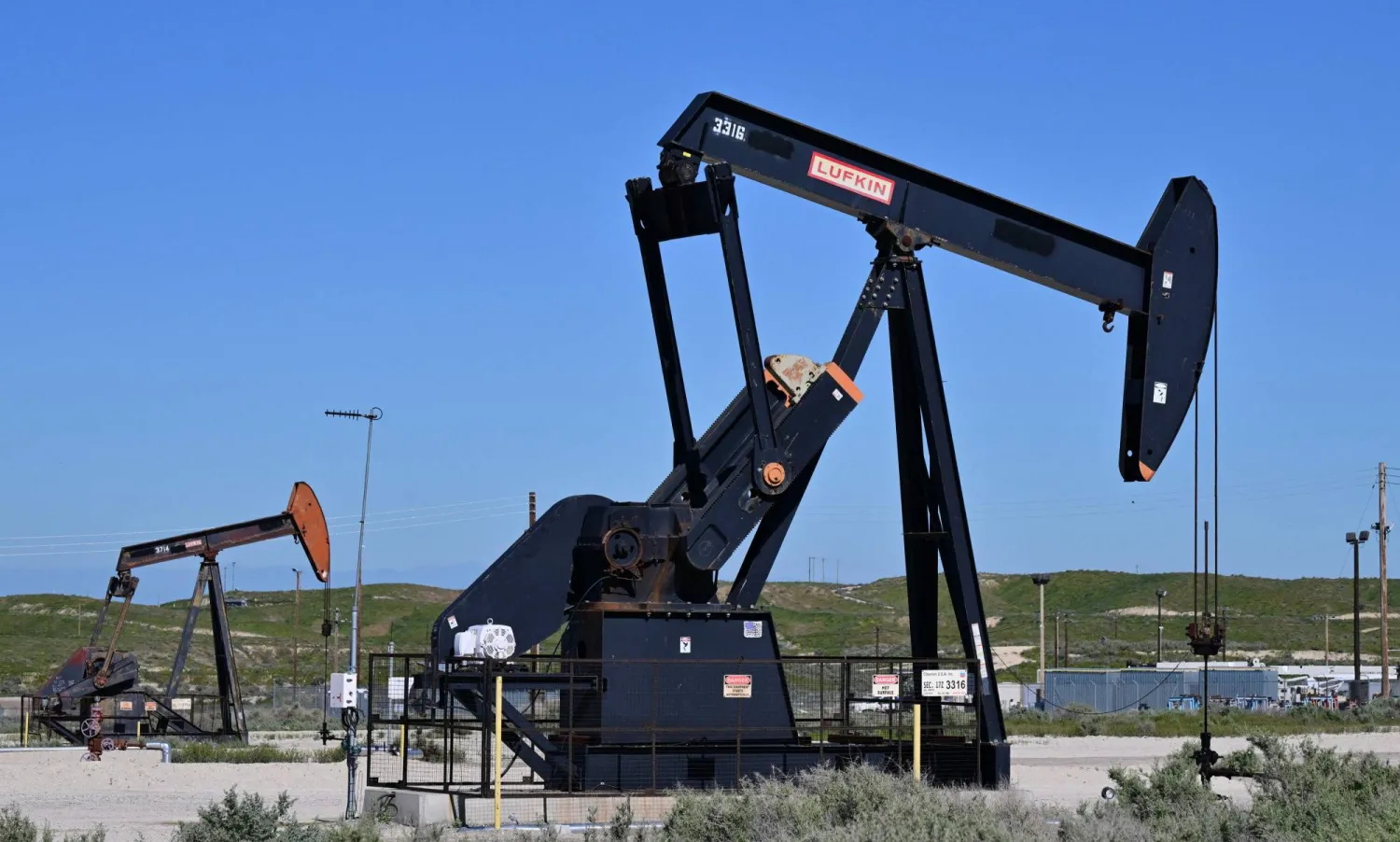 Pumpjacks work the wells operated by Chevron at Midway-Sunset field near Fellows, north of Taft, in Kern County, California, on March 8, 2026.  (Photo by Frederic J. BROWN / AFP)