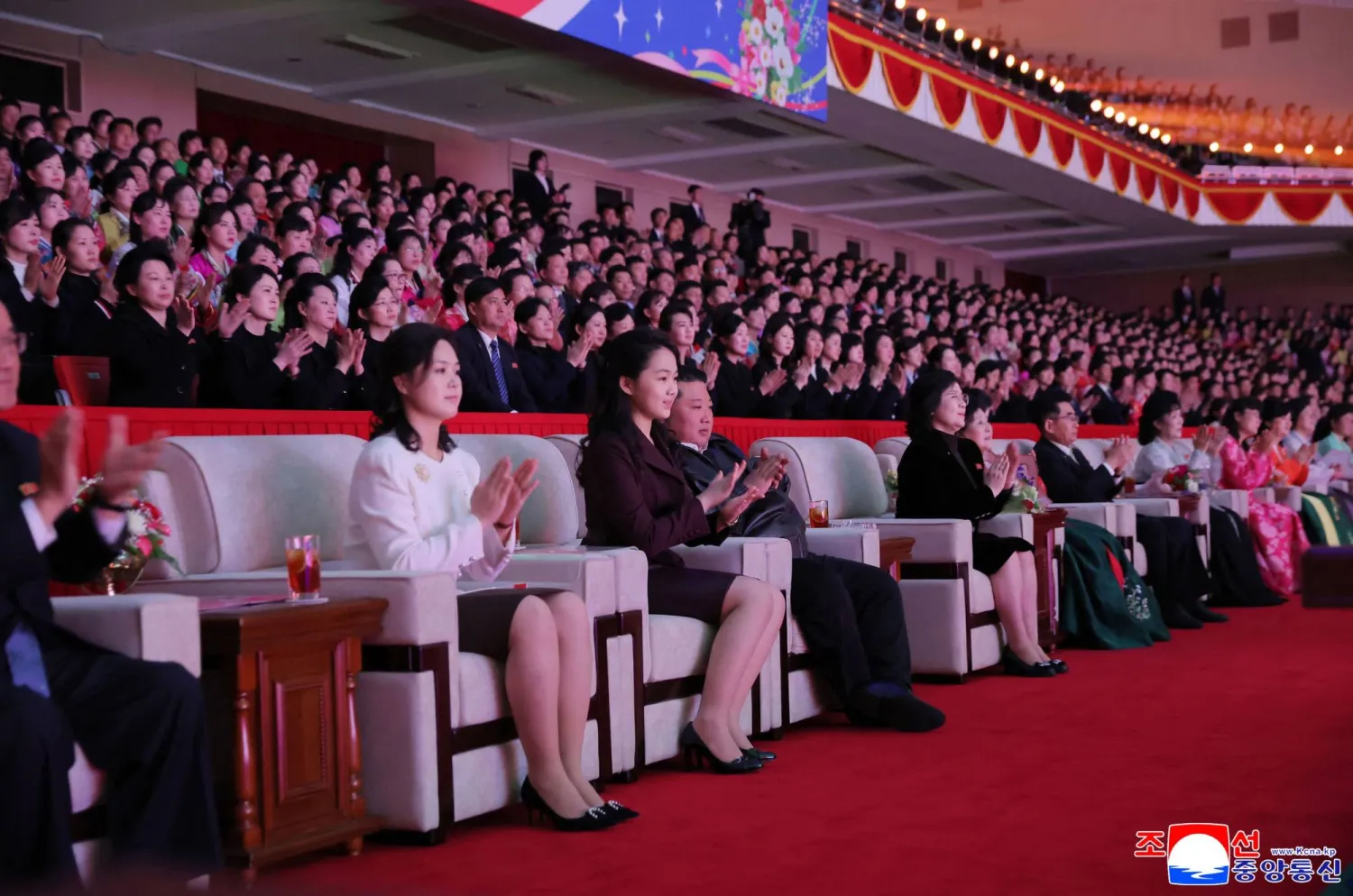 This picture taken on March 8, 2026 and released by North Korea's official Korean Central News Agency (KCNA) on March 9, 2026 shows North Korean leader Kim Jong Un (3rd L), his wife Ri Sol Ju (L), and their daughter Kim Ju Ae (2nd L) watching a performance commemorating International Women's Day at the Pyongyang Gymnasium. (KCNA VIA KNS / AFP)