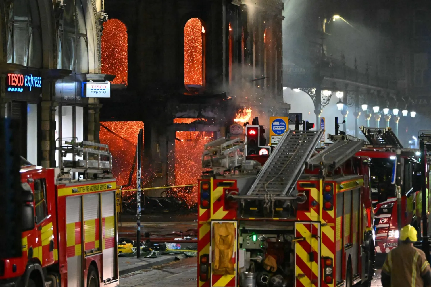  Floors collapse inside the building as fire fighters work at the site of a large fire in Glasgow City center on March 8, 2026. (AFP) 