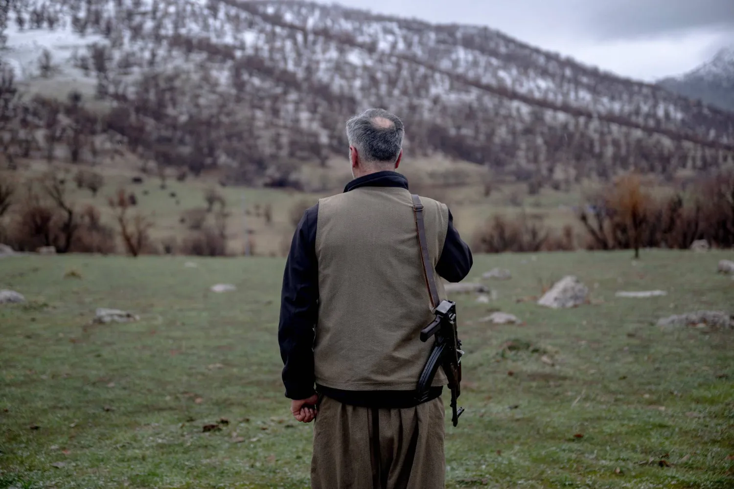 A Kurdish fighter from the Iranian Kurdish armed faction Kurdistan Free Life Party (PJAK) stands with his rifle at a site near the Iraqi border with Iran in Iraq's autonomous Kurdistan region, on March 8, 2026. (AFP)