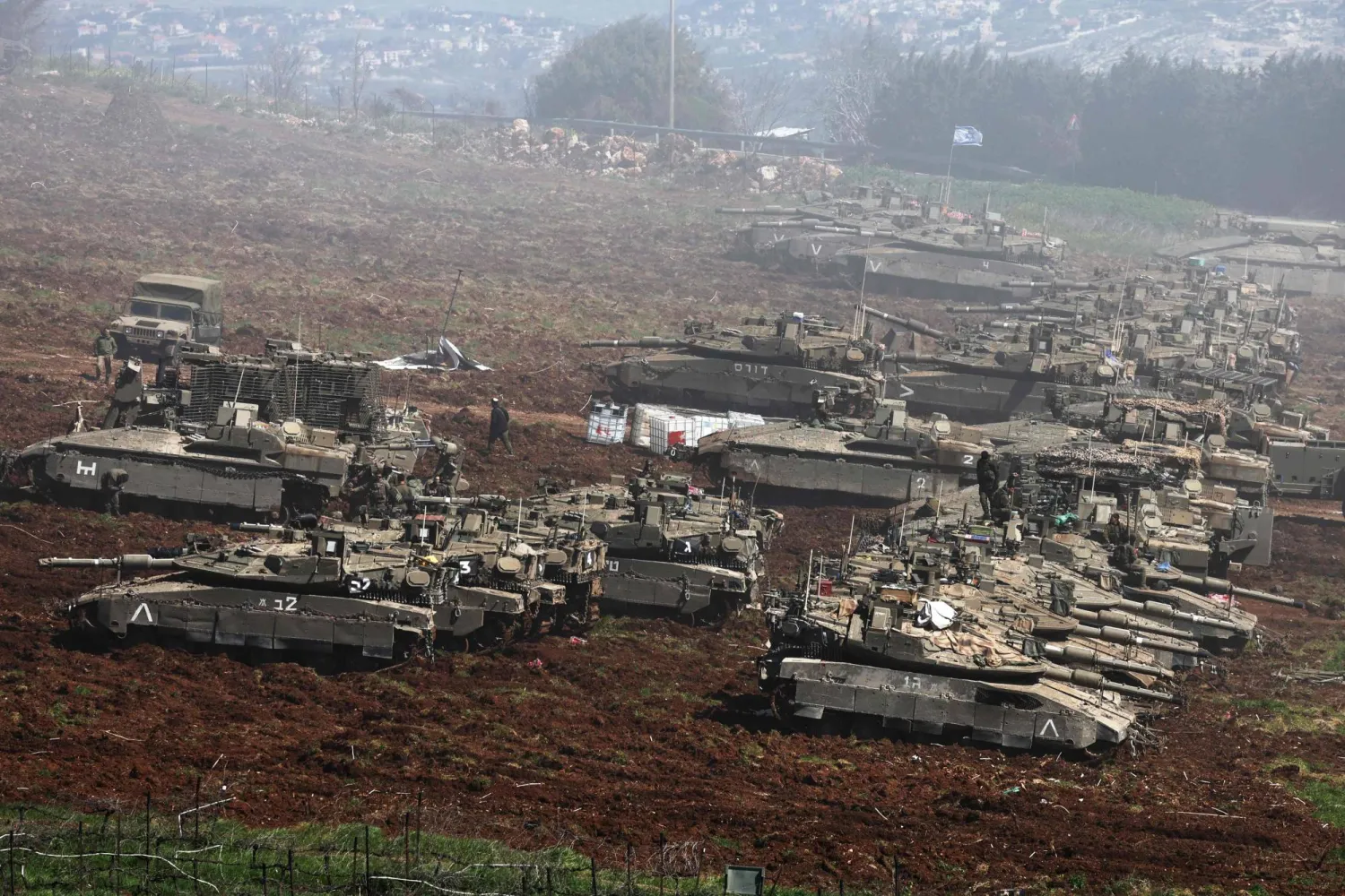  Israeli tanks gather at a position along the Israel-Lebanon border on March 8, 2026. (Photo by Jack GUEZ / AFP)