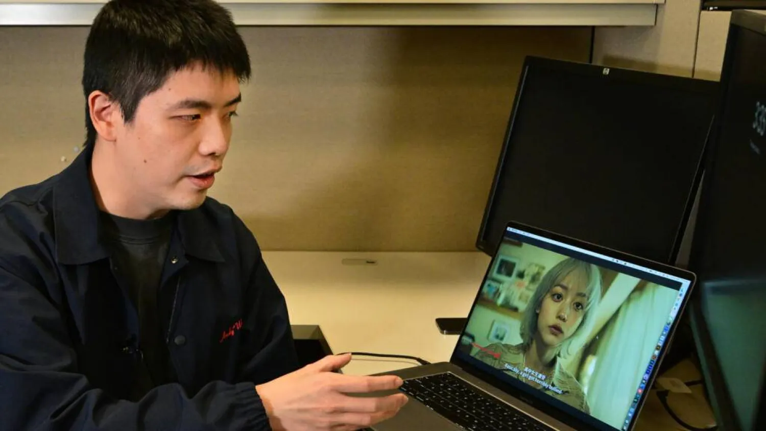 Chinese USC student SiJia Zheng speaks about how he used artificial intelligence to modify his face and make him into all the different characters of his short film 'Torment'. Frederic J. BROWN / AFP
