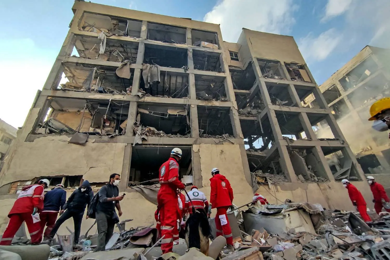  10 March 2026, Iran, Tehran: Members of the Iranian Red Crescent Society (IRCS) rescue teams work at the site of a building damaged in a US-Israeli airstrike in Resalat Square. (dpa)