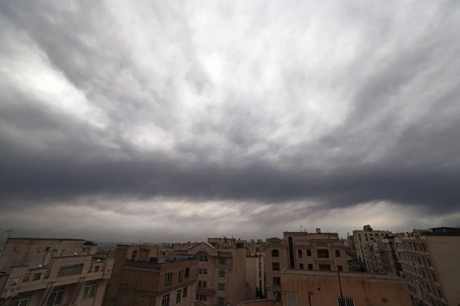 This photograph shows Tehran's skyline covered with clouds and smoke after overnight strike on the Tehran Oil Refinery, on March 8, 2026. (AFP)