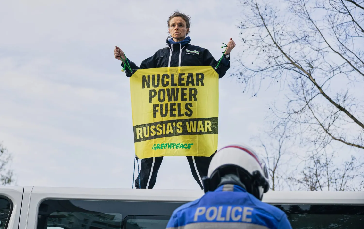 ناشط من منظمة «غرينبيس» يحمل لافتة على سطح شاحنة خلال احتجاج خارج قمة الطاقة النووية التابعة للوكالة الدولية للطاقة الذرية في باريس (أ.ب)