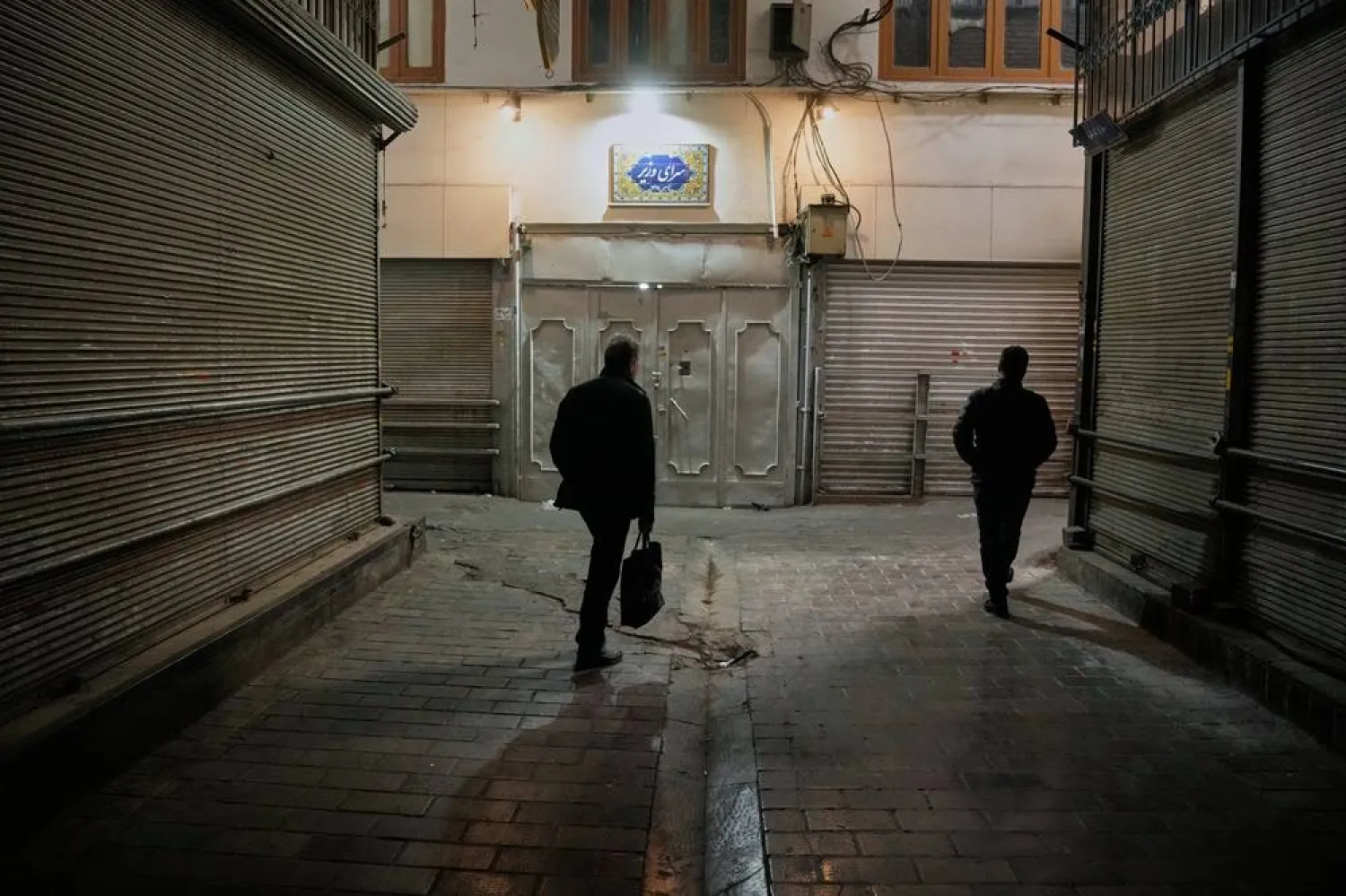  People walk past closed shops at the nearly empty Tajrish traditional bazaar in northern Tehran, Iran, Tuesday, March 10, 2026. (AP)