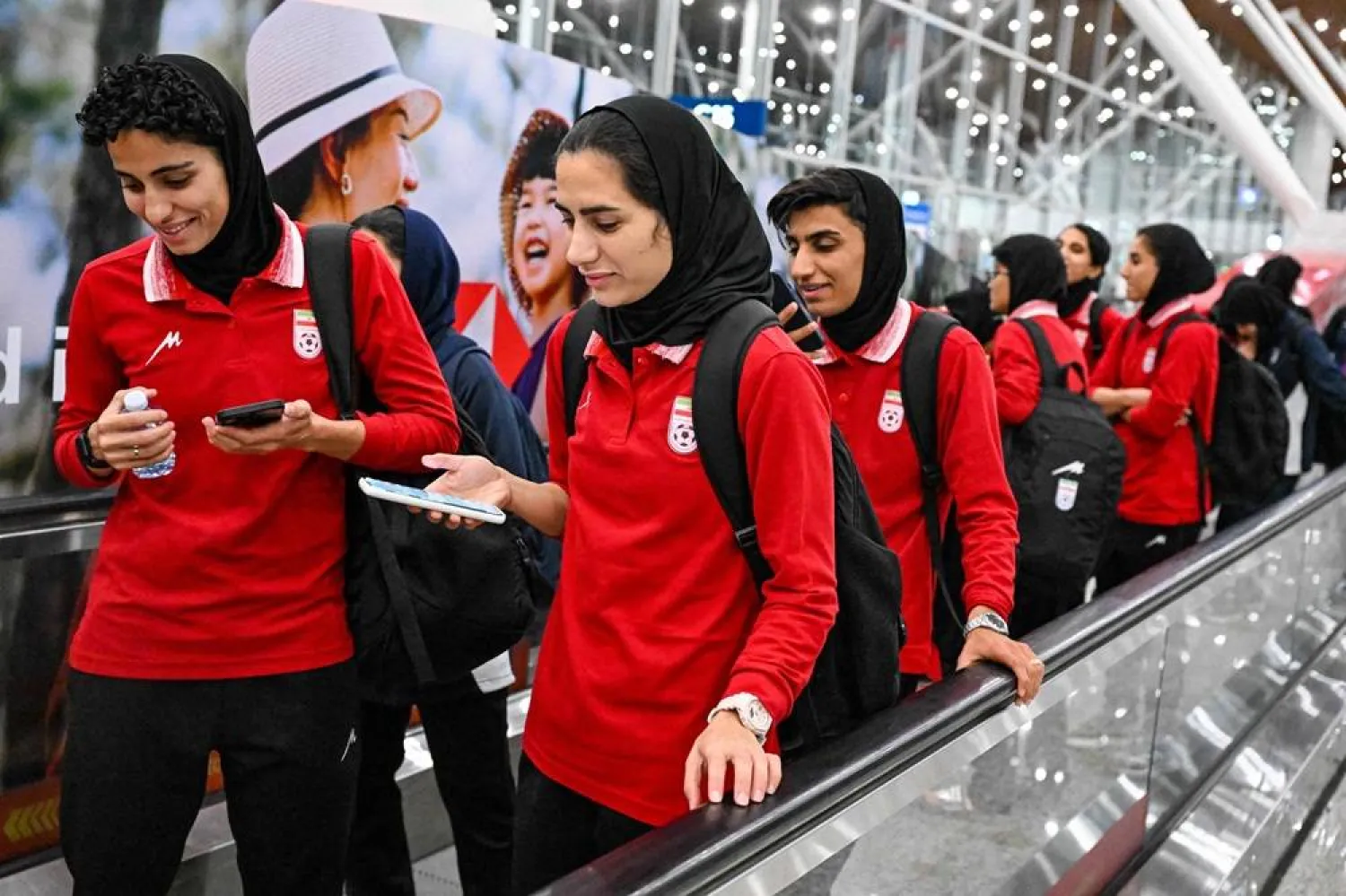 Members of Iran's women's football team walk as they arrive at the Kuala Lumpur International Airport after taking part in the AFC Women's Asian Cup Australia 2026 tournament in Australia, in Sepang on March 11, 2026. (AFP)