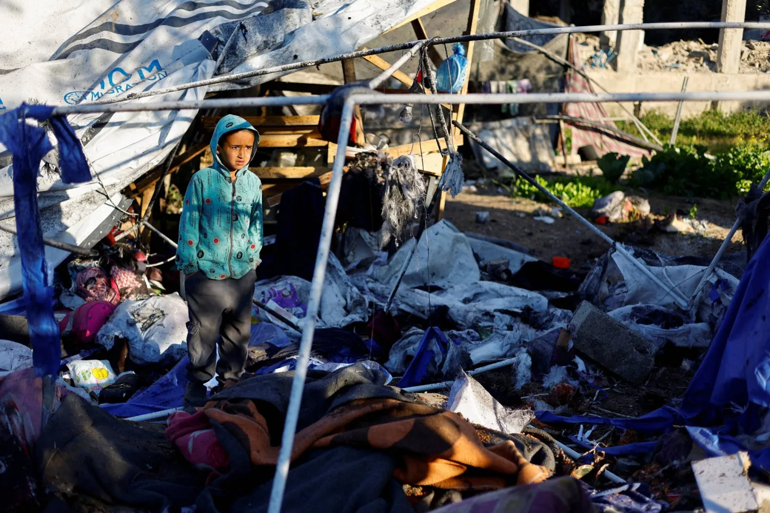 A boy stands at the site of an Israeli strike on a tent sheltering displaced people, in Nuseirat, central Gaza Strip March 9, 2026. REUTERS/Mahmoud Issa 