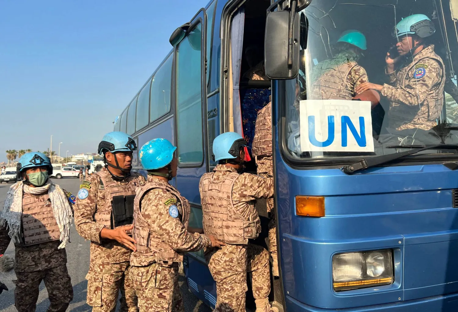 Members of the UNIFIL peacekeeping force enter a bus at the site of an Israeli strike at the northern entrance of the southern city of Sidon, on November 7, 2024, amid the ongoing war between Israel and Hezbollah.  (Photo by Mahmoud ZAYAT / AFP)
