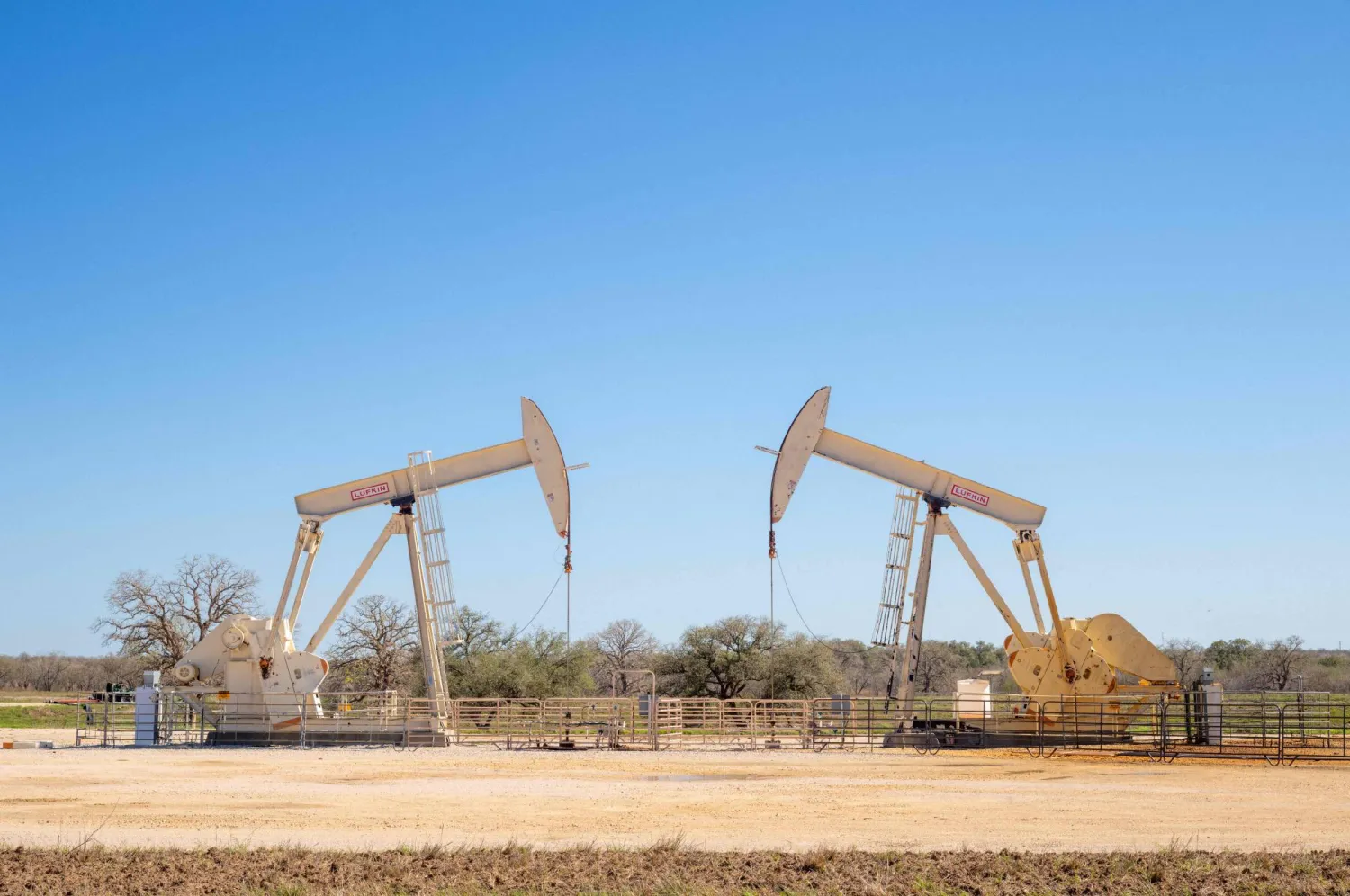 GILLETT, TEXAS - MARCH 11: Pump jacks operate in a field on March 11, 2026 in Gillett, Texas. Brandon Bell/Getty Images/AFP