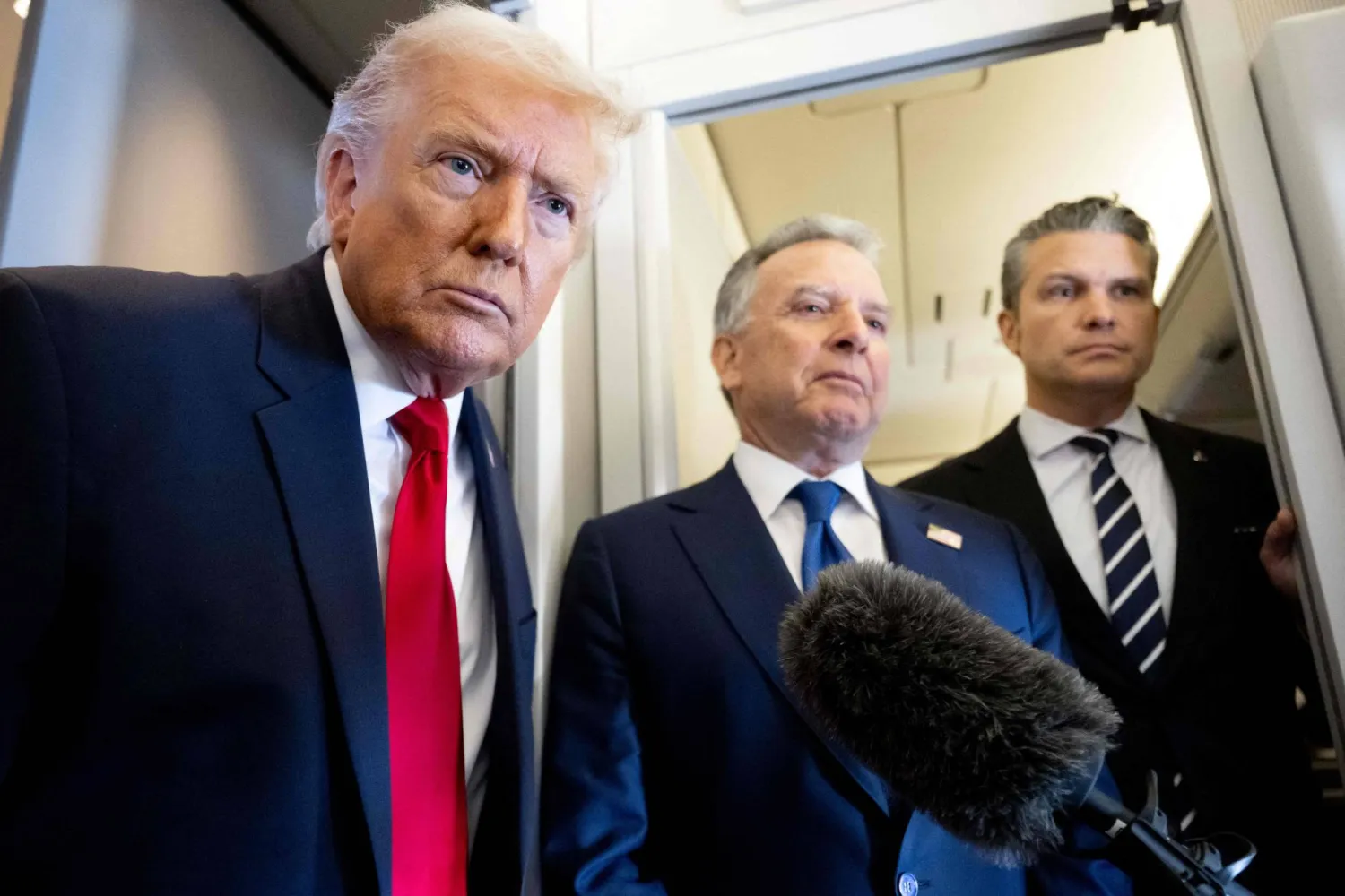 US President Donald Trump speaks with the media as Defense Secretary Pete Hegseth (R) and special envoy Steve Witkoff (C) look on aboard Air Force One during a flight from Dover, Delaware, to Miami, Florida, on March 7, 2026. (AFP)