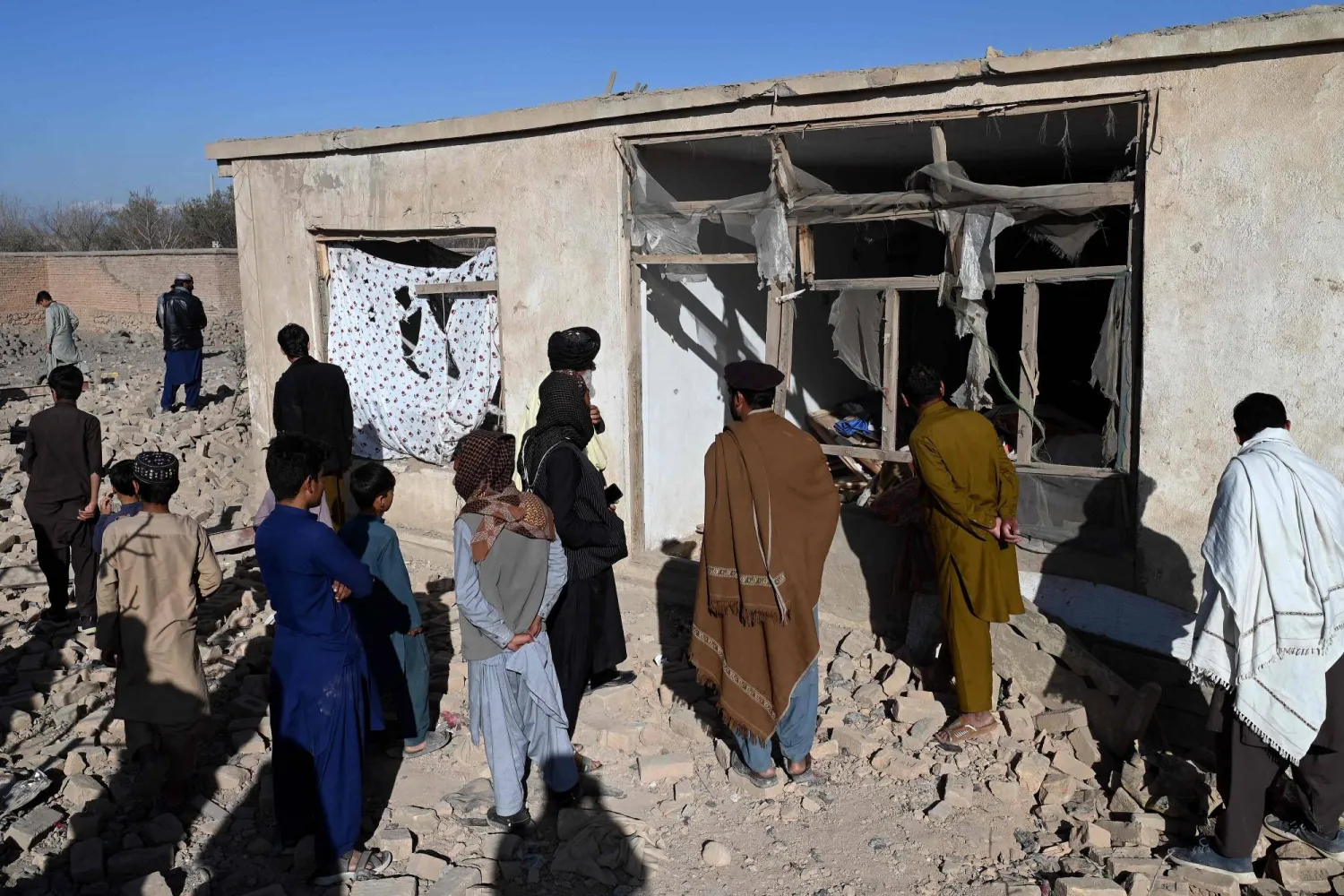 Afghans inspect a damaged house at the site of an overnight Pakistan airstrike, at a residential area in Pol-e-Charkhi on the outskirts of Kabul on March 13, 2026. (AFP)