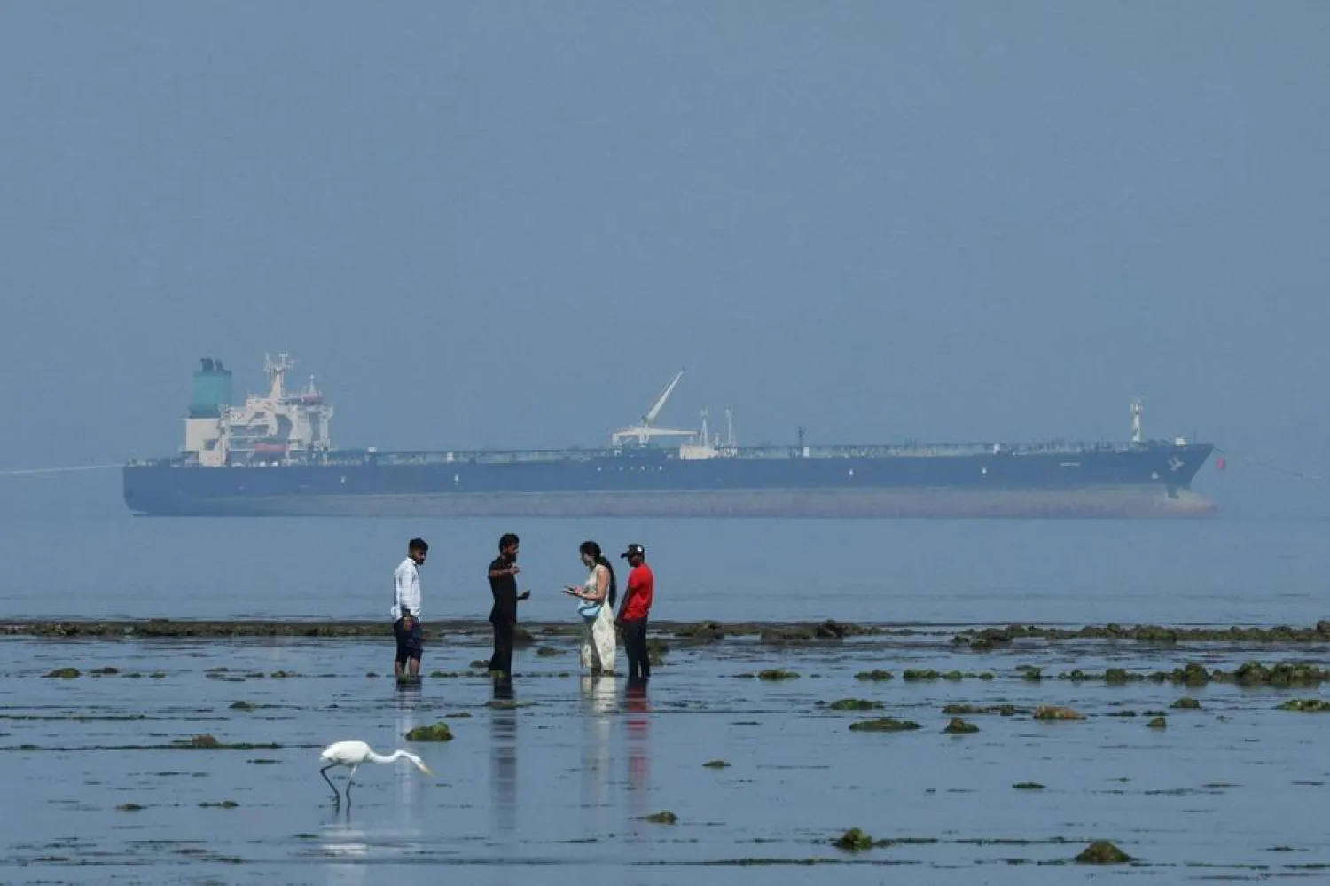 Tourists watch marine life, with the MT Desert Kite oil tanker carrying Russian oil in the background, at Narara Marine National Park in the Arabian Sea, Gujarat, India March 11 , 2026. (Reuters)